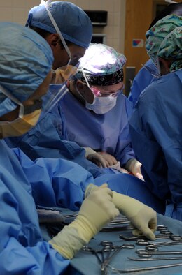 Members of the 366th Surgical Operations Squadron operate on a patient, July 29, 2013, at Mountain Home Air Force Base, Idaho. During a typical surgery, there’s an anesthesia provider, at least one surgeon, one operating-room scrub tech and a nurse working together to take care of the patient. (U.S. Air Force photo by Airman 1st Class Shane M. Phipps/Released)

