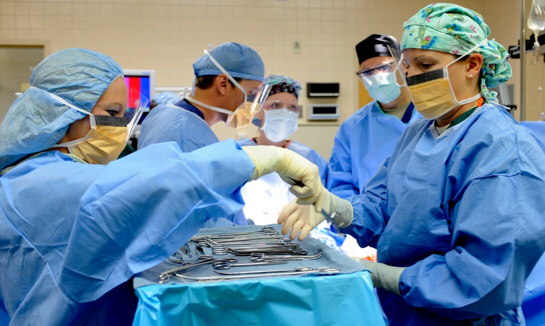 A surgical technician hands a medical instrument to a teammate during an operation, July 29, 2013, at Mountain Home Air Force Base, Idaho. For most, this might seem like a scene straight out of “Grey’s Anatomy,” but it’s simply another day-in-the-life for the members from the 366th Surgical Operations Squadron. (U.S. Air Force photo by Airman 1st Class Shane M. Phipps/Released)
