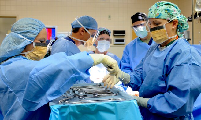 A surgical technician hands a medical instrument to a teammate during an operation, July 29, 2013, at Mountain Home Air Force Base, Idaho. For most, this might seem like a scene straight out of “Grey’s Anatomy,” but it’s simply another day-in-the-life for the members from the 366th Surgical Operations Squadron. (U.S. Air Force photo by Airman 1st Class Shane M. Phipps/Released)
