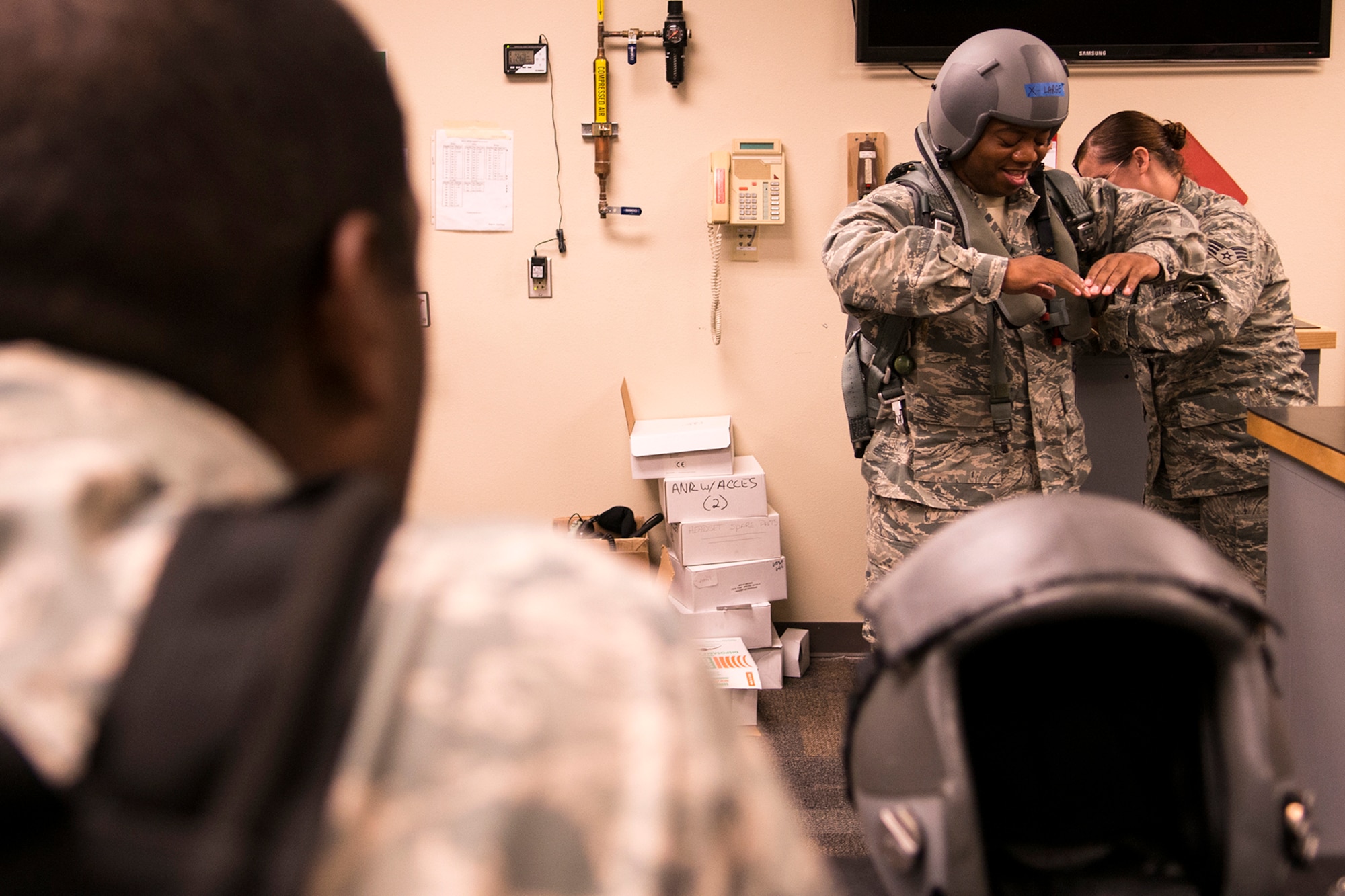 A Chaplain candidate tries on a parachute during a tour of the 307th Operations Support Flight Aircrew Flight Equipment shop during a tour of Barksdale Air Force Base, La., Aug. 5, 2013. The candidates spent four days at Barksdale, touring different sections of the 307th Bomb Wing to gain first-hand knowledge of the different Air Force missions. (U.S. Air Force photo by Master Sgt. Greg Steele/Released)