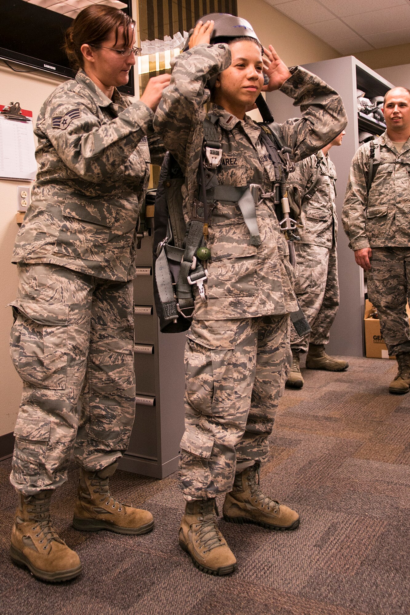 U.S. Air Force 1st. Lt. Iraida Alvarez gets to experience for herself the equipment a B-52H Stratofortress aircrew member is required to wear on a mission at Barksdale Air Force Base, La., Aug. 5, 2013. Alvarez is an intern in the Chaplain Candidate program and is getting a first-hand look at the different Air Force organizations and missions. (U.S. Air Force photo by Master Sgt. Greg Steele/Released)