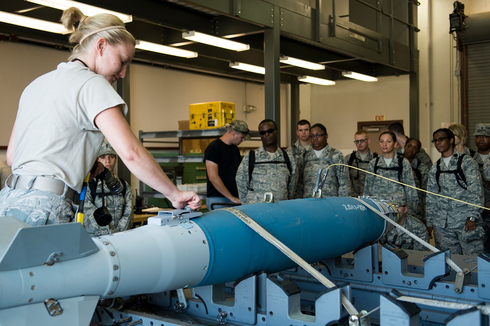 U.S. Air Force Senior Airman Amanda Chartran, 307th Maintenance Squadron munitions technician, performs a functional check on an inert GBU-38 munition during a Chaplains Candidate visit, Aug 5, 2013, Barksdale Air Force Base, La. The candidates visited Barksdale to gain exposure to the different aspects of the Air Force and the unique spiritual needs of different units. (U.S. Air Force photo by Master Sgt. Greg Steele/Released)