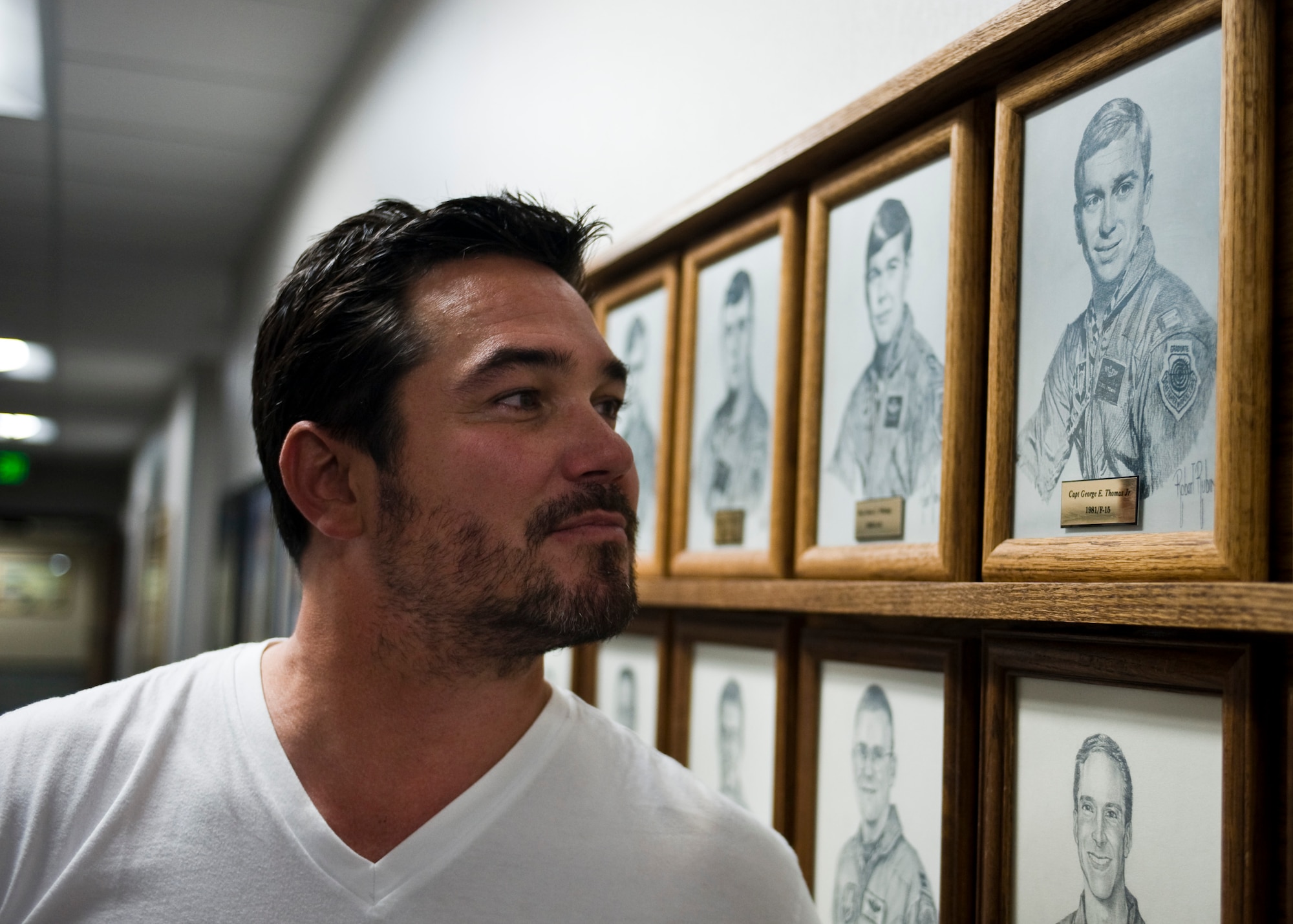 Actor Dean Cain looks at an illustration of his uncle, retired Lt. Col. George Thomas, at the U.S. Air Force Weapons School Aug. 2, 2013, at Nellis Air Force Base, Nev. Cain visited Nellis AFB to view his uncle’s Risner Award Portrait and to learn about the base and its Airmen. The Risner award is presented annually to an outstanding graduate of the USAFWS. Cain is known for his role as Superman in the TV series “Lois & Clark: The New Adventures of Superman.” (U.S. Air Force photo by Airman 1st Class Jason Couillard)