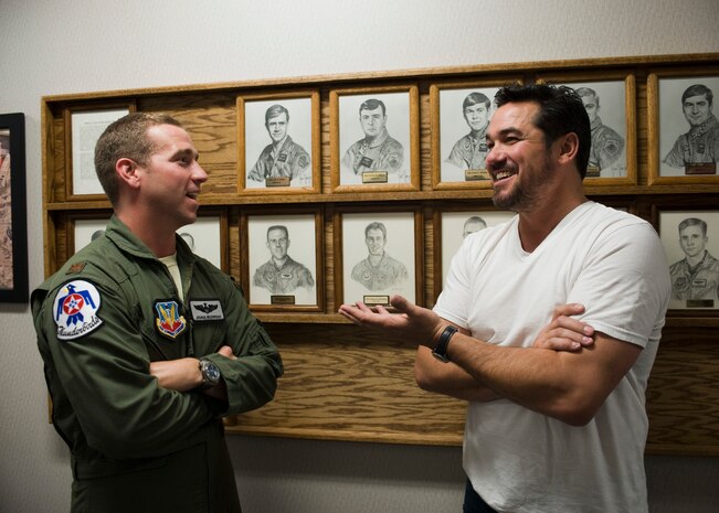 Maj. Joshua Boudreaux, United States Air Force Air Demonstration Squadron-Thunderbirds pilot, speaks with actor Dean Cain at the U.S. Air Force Weapons School Aug. 2, 2013, at Nellis Air Force Base, Nev. Cain's uncle, retired Lt. Col. George Thomas, is a weapons school graduate and F-15C Eagle pilot who received the Risner award in 1981. The Risner award is presented annually to an outstanding graduate of the USAFWS.  (U.S. Air Force photo by Airman 1st Class Jason Couillard)