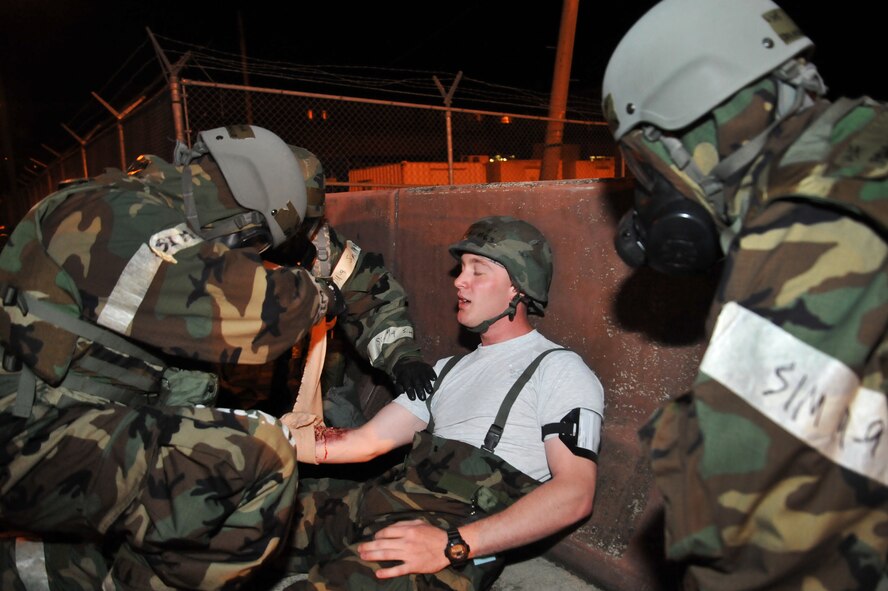 First responders tend to the wounds of a role player during a mass casualty exercise scenario during Operational Readiness Exercise Beverly Midnight 13-03 at Osan Air Base, Republic of Korea, August 6, 2013. The exercise highlights Osan Airmen’s ability to position, employ and sustain forces, and showcase operational readiness. (U.S. Air Force photo/Staff Sgt. Emerson Nuñez)