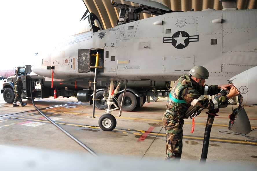 Staff Sgt. Caleb Parton, 51st Aircraft Maintenance Squadron crew chief, attaches a fuel hose to an A-10 Thunderbolt during Operational Readiness Exercise Beverly Midnight 13-03 at Osan Air Base, Republic of Korea, August 6, 2013. Osan Airmen are in the fourth simulated wartime contingency exercise executed in 2013 that will test the base's ability to defend and execute the mission in a heightened state of readiness. (U.S. Air Force photo/Staff Sgt. Emerson Nuñez)