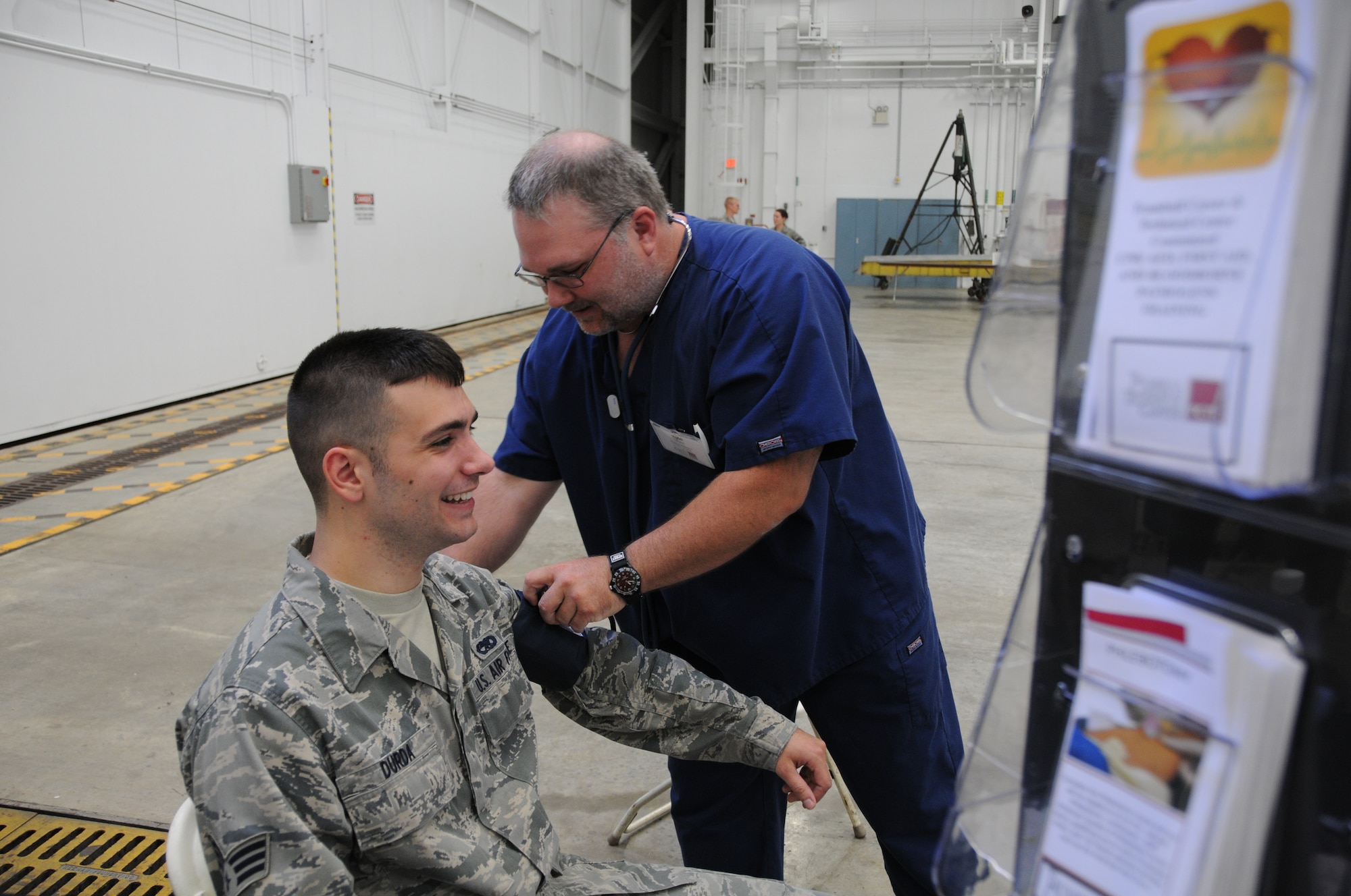 YOUNGSTOWN AIR RESERVE STATION, Ohio—Air Force Reserve Senior Airman Jonathon Durda, 910th Maintenance Squadron aerospace maintenance journeyman, gets his blood pressure checked during the job, information and education fair held during family day here, August 4. Family day is a yearly open house held for Citizen Airmen and their families, designed to let Reserve families strengthen bonds and experience the home station of their Reservist loved one. U.S. Air Force photo by SrA Rachel Kocin.