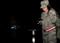 KUNSAN AIR BASE, Republic of Korea -- Airman 1st Class Marina Clark, 8th Civil Engineer Squadron exercise post-attack reconnaissance team member, investigates a liquid detection point during an operational readiness exercise Aug. 7, 2013.  PAR teams conduct sweeps of their designated areas to survey for damage, unexploded ordinance and contamination.  (U.S. Air Force photo by Senior Airman Armando A. Schwier-Morales/ Released)