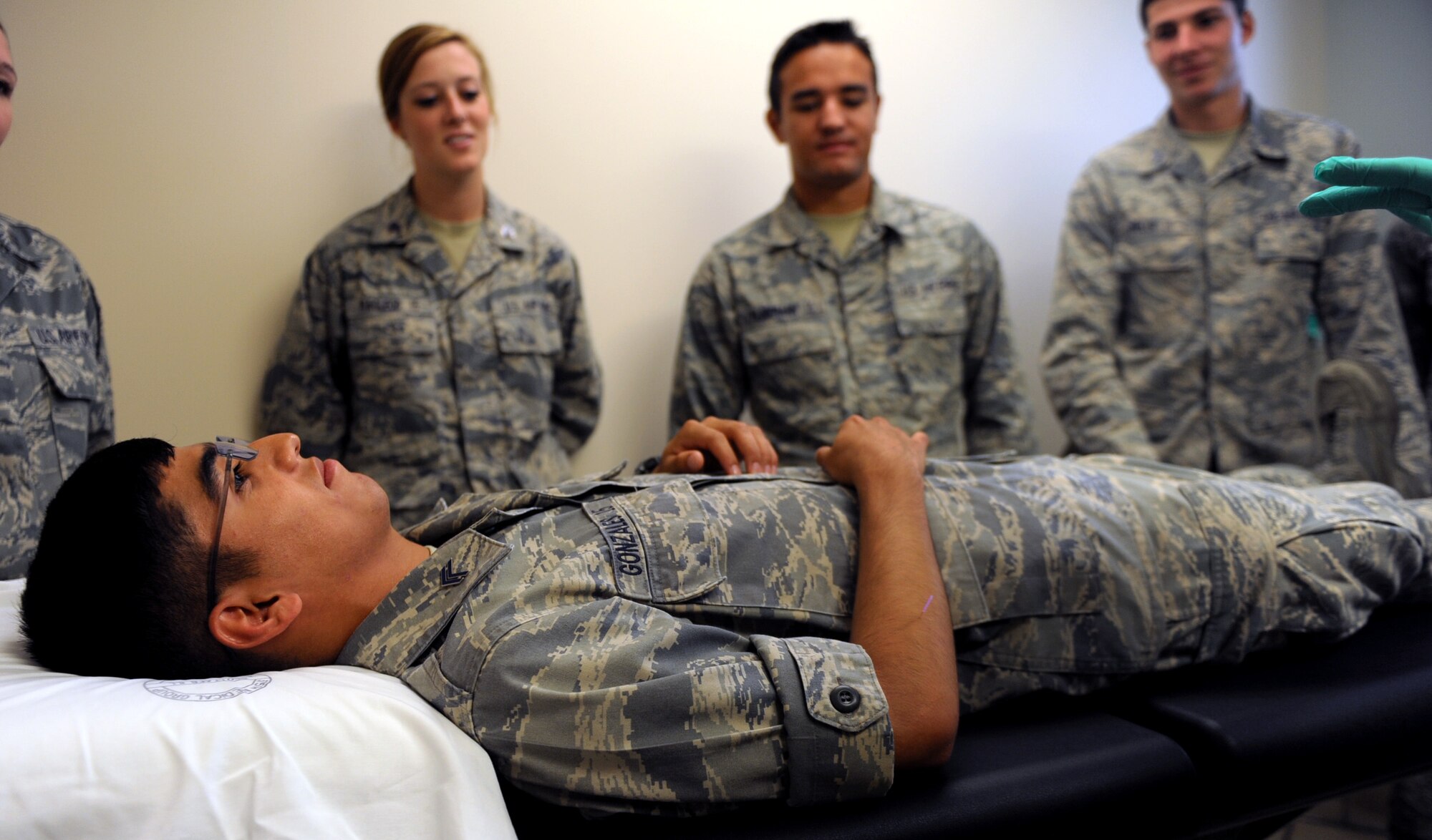 United States Air Force Academy cadet Justin Gonzales, has dry needles placed in his arms July 26, 2013 at Scott Air Force Base, Ill. Dry needling is a general term for a therapeutic treatment procedure that involves multiple advances of a filament needle into the muscle in the area of the body, which produces pain and typically contains a trigger point. The cadets visited different squadrons on base to get a feel of the everyday jobs of the Air Force. (U.S. Air Force photo/Airman 1st Class Jaeda Waffer)
