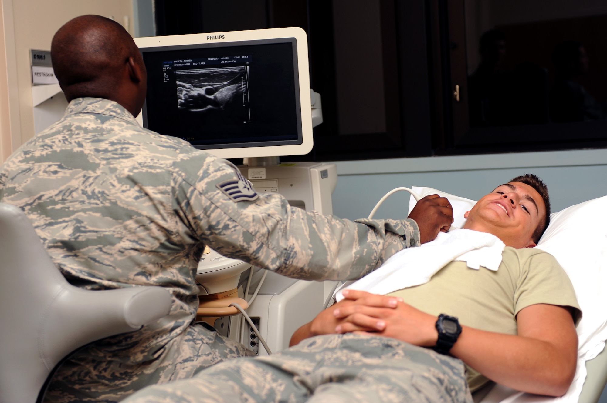 Staff Sgt. Mycal King, 375th Medical Support Squadron ultrasound technician, does an ultrasound on Cadet 2nd Class Drew Barrera, United States Air Force Academy student, July 26, 2013 at Scott Air Force Base, Ill. The cadets visited different squadrons on base to get a feel of the everyday jobs of the Air Force. (U.S. Air Force photo/Airman 1st Class Jaeda Waffer)