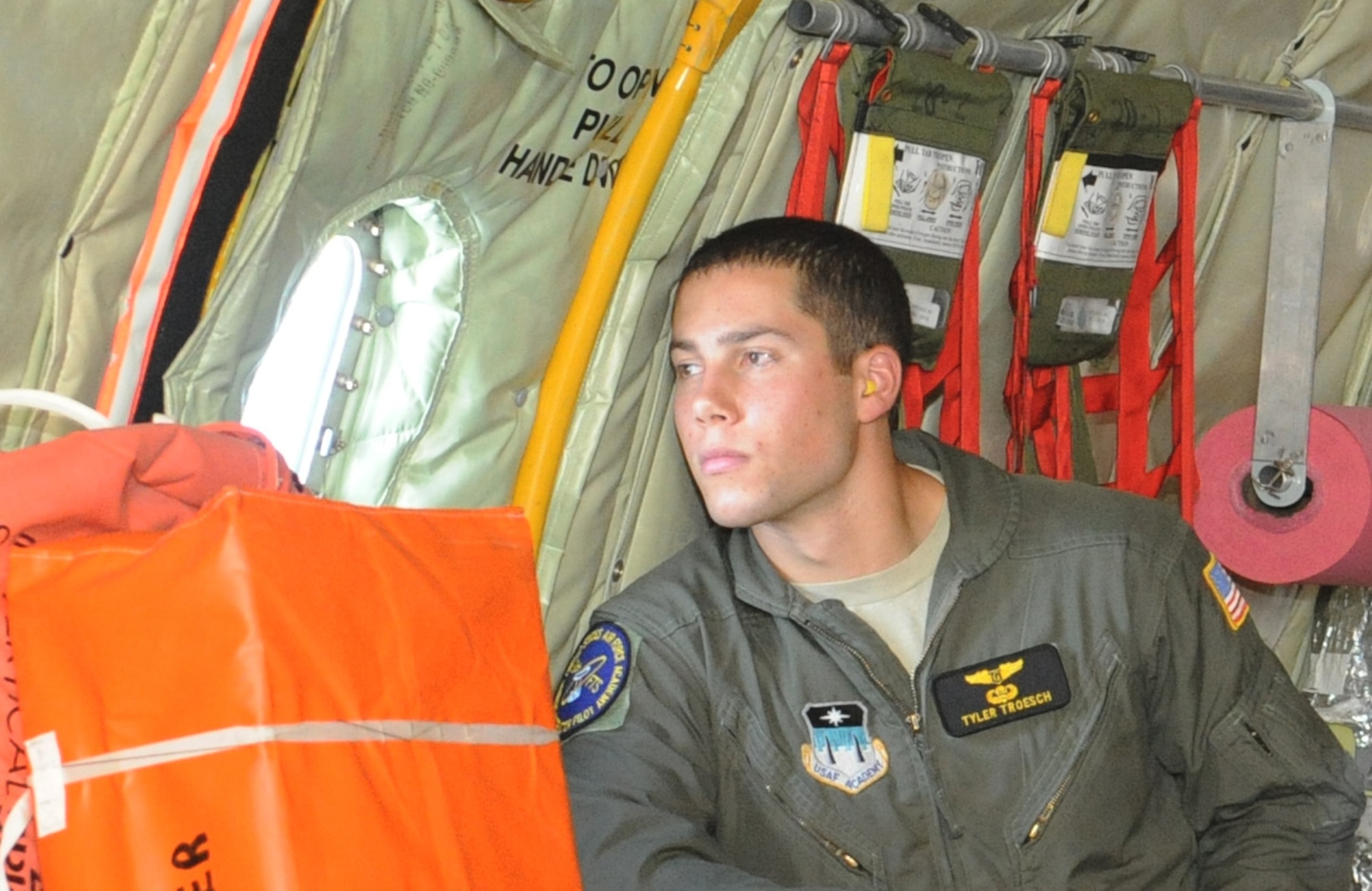 Tyler Troesch, a U.S. Air Force Academy cadet, looks out the window of the U.S. KC-135R Stratotanker during a flight to Ohio July 25, 2013.  The aircraft was heading out to refuel two F-16 Fighter Falcons from the 180th Fighter Wing as part of a local training sortie.  .  (U.S. Air Force photo by Staff Sgt. Maria Bowman)