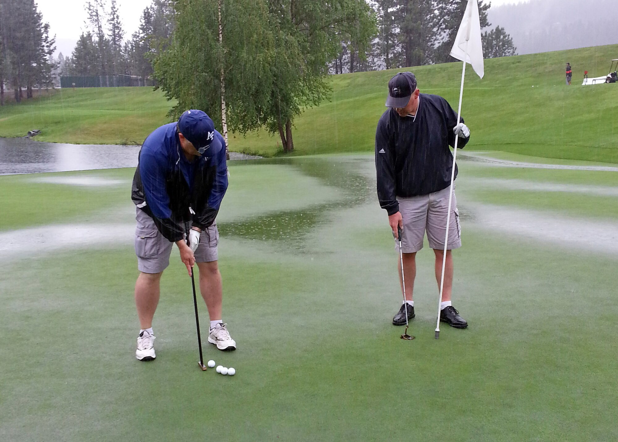 Dan Holland, 92nd Air Refueling Wing chief of command post, putts the ball during the Annual 92nd Air Refueling Wing Golf Tournament at the Creek at Qualchan Golf Course in Spokane, Wash., Aug. 2, 2013. (U.S. Air Force photo by Senior Airman Taylor Curry/ Released)
