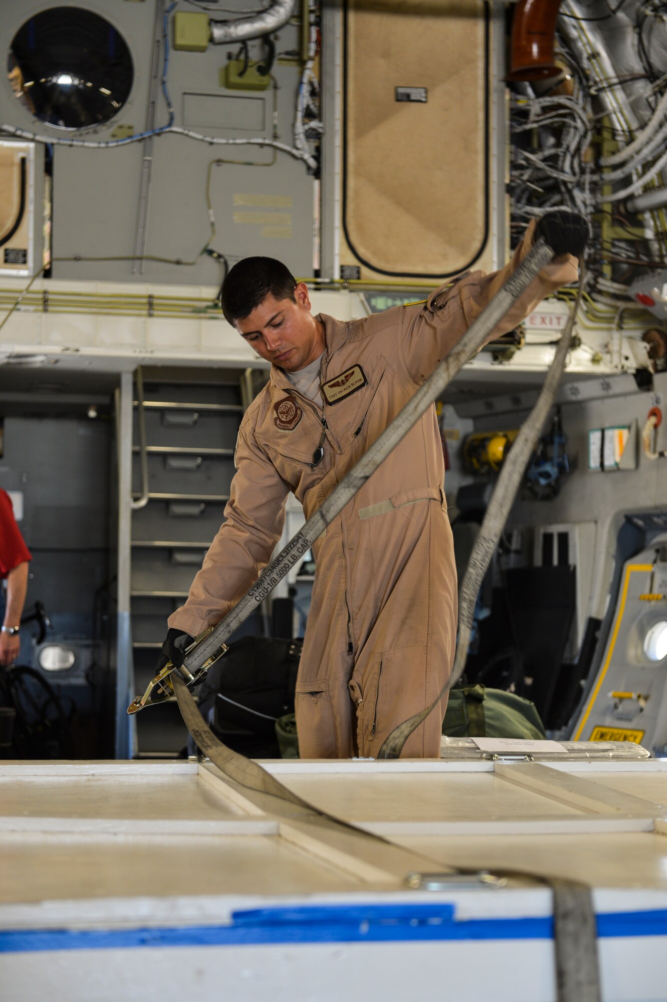 Tech. Sgt. Patrick Bloom, 21st Airlift Squadron loadmaster and native of Highlands Ranch, Colo., secures a part of the Mars Atmosphere and Volatile Evolution Mission spacecraft Aug. 2, 2013, at Buckley Air Force Base, Colo. The MAVEN spacecraft is built out of aluminum and graphite and weighs 275 pounds. (U.S. Air Force photo by Staff Sgt. Paul Labbe/Released)