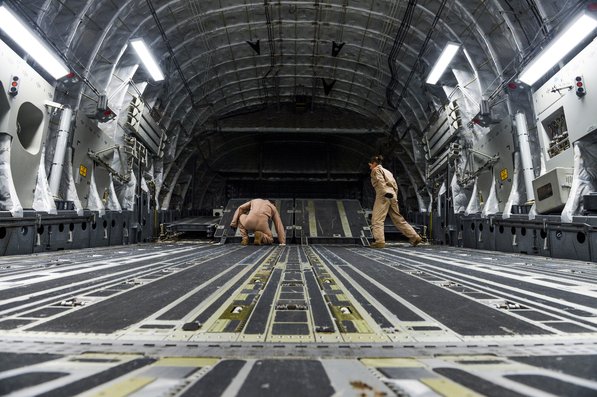 Tech. Sgt. Patrick Bloom, 21st Airlift Squadron loadmaster and native of Highlands Ranch, Colo., left, and Senior Airman Desiree Lemus, 21st AS loadmaster and native of Homestead, Fla., configure the back of a C-17 Globemaster III Aug. 2, 2013, at Buckley Air Force Base, Colo.  The C-17 can carry about 170,000 pounds of cargo. (U.S. Air Force photo by Staff Sgt. Paul Labbe/Released)