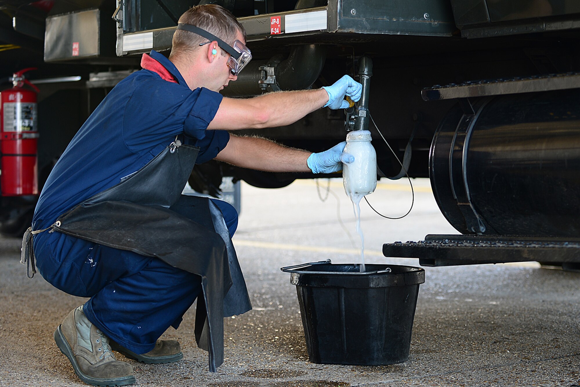 Senior Airman Vernoy Tate, 48th Logistics Readiness Squadron fuels technician, extracts a fuel sample from an R-11 refueling truck while performing a checkpoint inspection during a Logistics Compliance Assessment Program inspection at Royal Air Force Lakenheath, England, August 6, 2013. The LCAP is held bi-annually to ensure all logistics and maintenance squadrons are able to perform key logistics processes in a compliant manner. (U.S. Air Force photo by Airman 1st Class Dana J. Butler/Released)