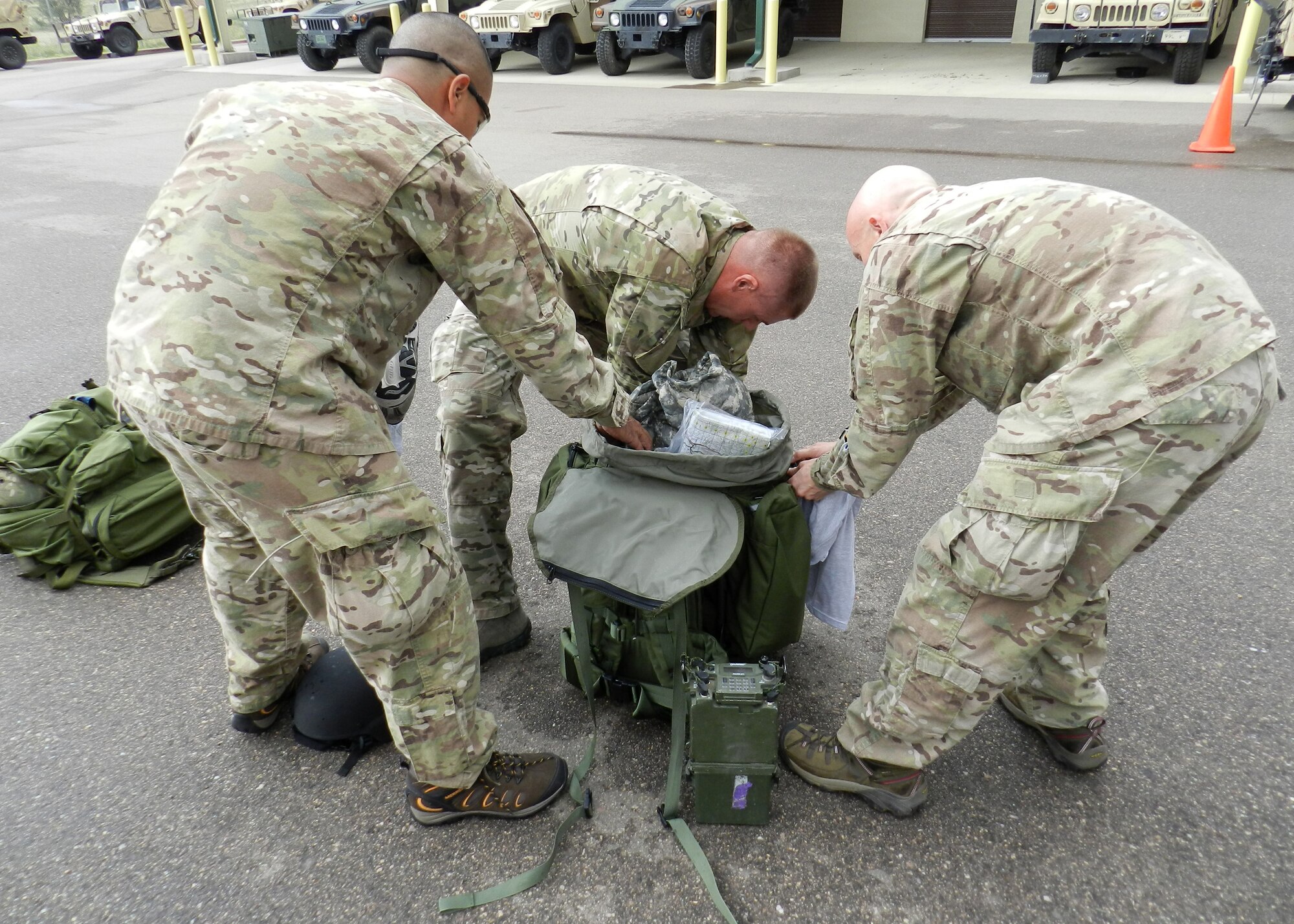 FORT CARSON, Colo. – Air liaison officers assigned to the 13th Air Support Operations Squadron scramble to retrieve specific items buried within their ruck sacks during a training exercise July 25. This portion of the exercise was to emphasize the importance of knowing the location of each item within their rucks for quick retrieval during deployed operations. (U.S. Air Force photo)