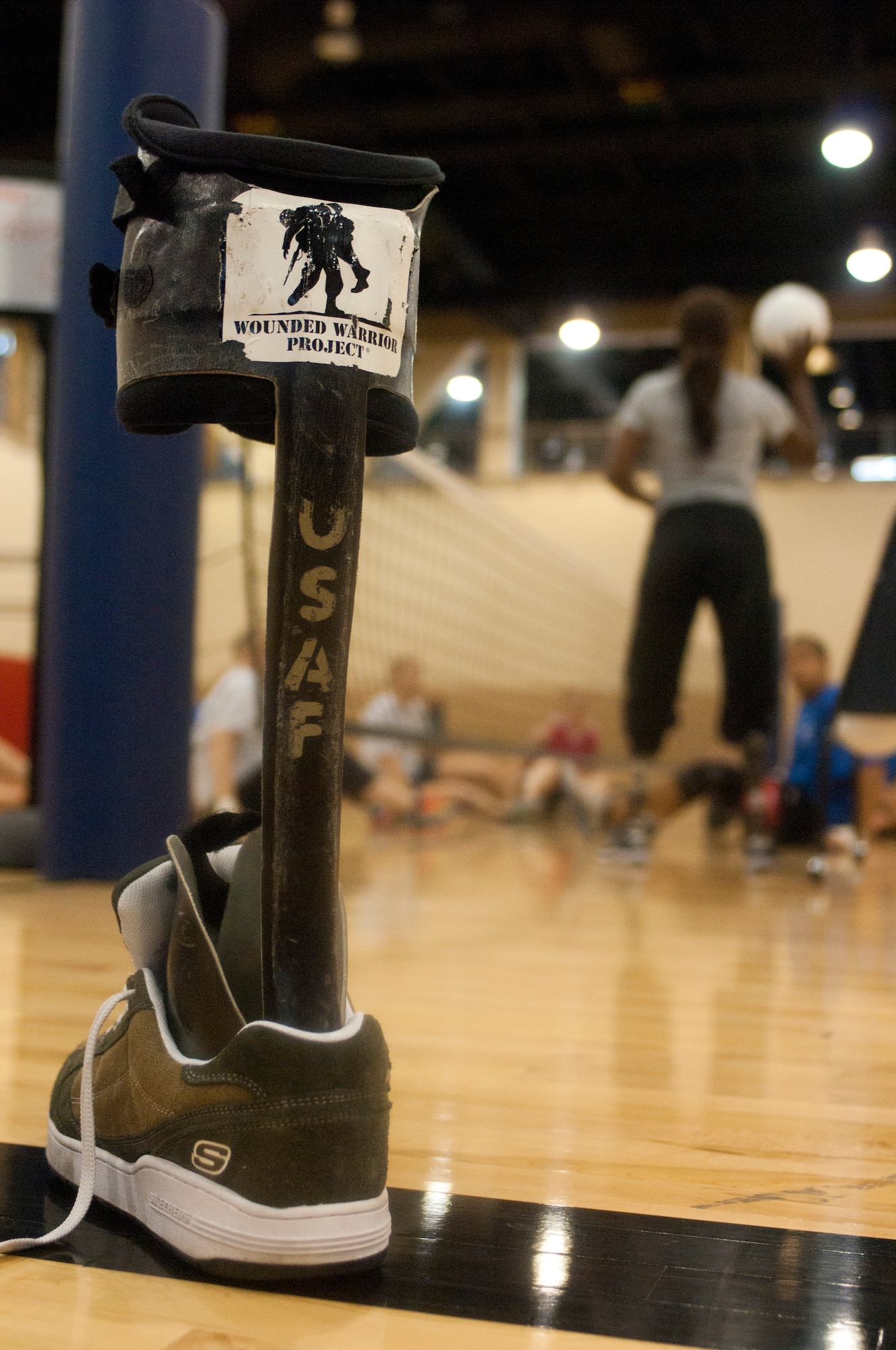 A prosthetic leg brace stands on the sidelines while its owner participates in a sit volleyball clinic during the Air Force Wounded Warrior Adaptive Sports Camp at the Warrior Fitness Center July 31, 2013, at Nellis Air Force Base, Nev. The camp is designed to introduce wounded warriors to sports that are featured in Paralympic competitions such as the Warrior Games. (U.S. Air Force photo by Airman 1st Class Joshua Kleinholz)