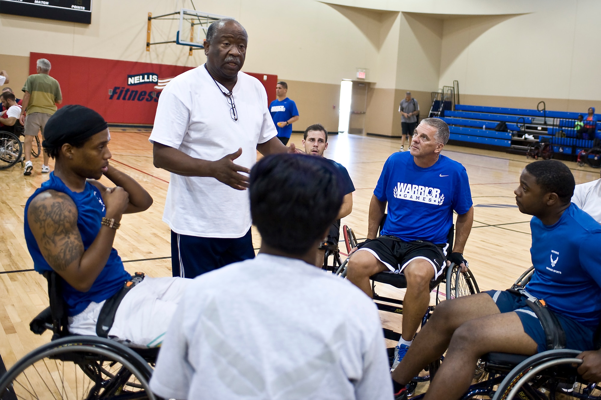 Bill Demby, Air Force Wounded Warrior Adaptive Sports Camp wheelchair basketball coach, speaks to the wheelchair basketball team during the Air Force Wounded Warrior Adaptive Sports Camp at the Warrior Fitness Center Aug. 1, 2013, at Nellis Air Force Base, Nev. Demby coaches wheelchair basketball to all service branches’ wounded warriors and participates with military sports camps six times a year. (U.S. Air Force photo by Senior Airman Matthew Lancaster)