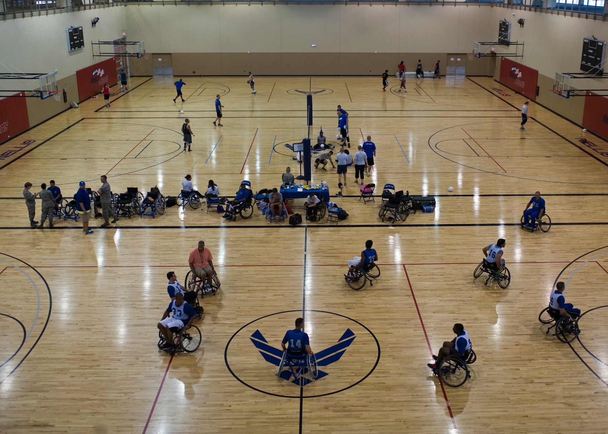 Wounded warriors participate in the Air Force Wounded Warrior Adaptive Sports Camp at the Warrior Fitness Center July 31, 2013, at Nellis Air Force Base, Nev. The activities included a wheelchair basketball clinic, sit volleyball clinic, adaptive cycling, shooting, yoga and track training. (U.S. Air Force Photo by Airman 1st Class Jason Couillard)