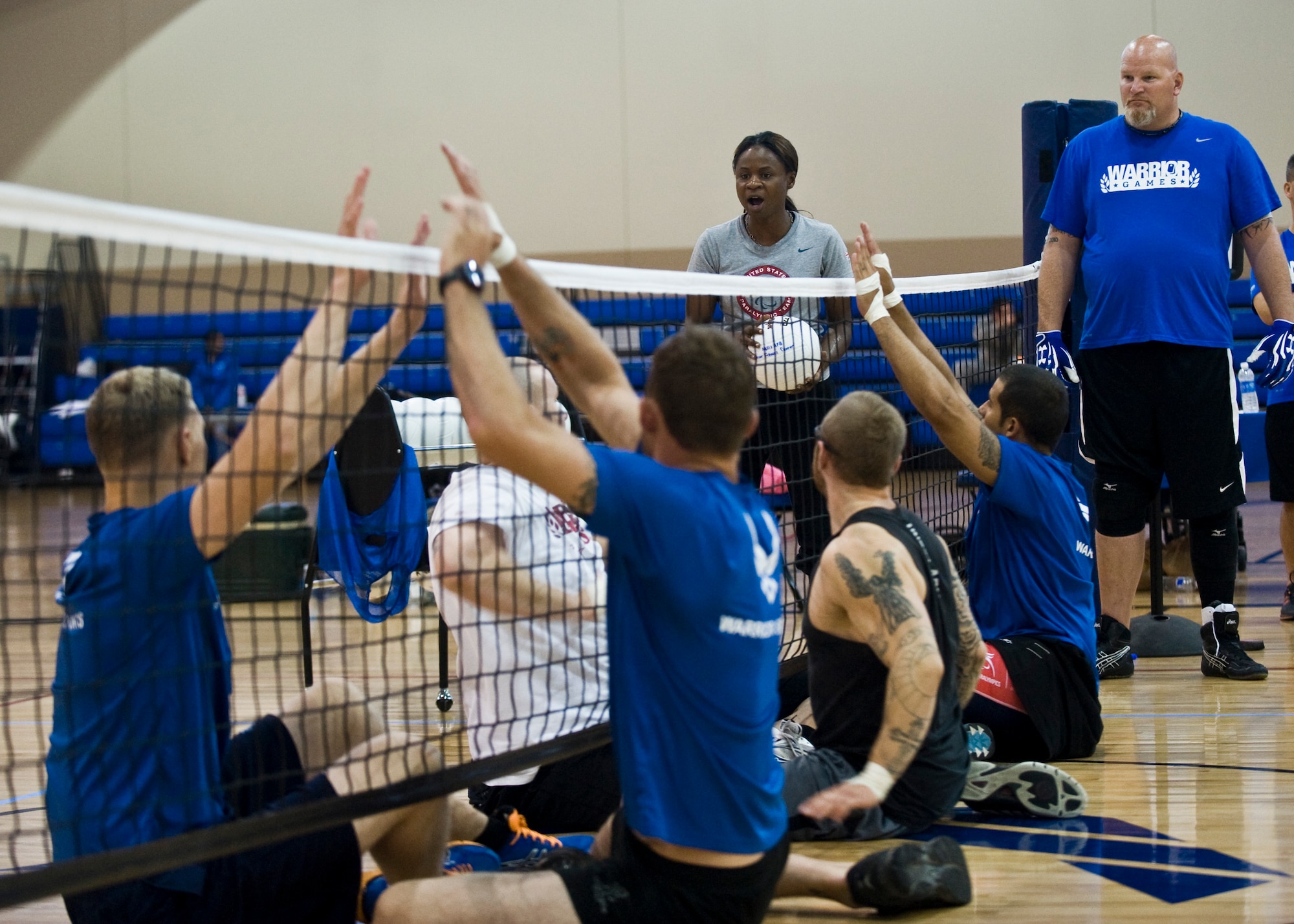 Kari Miller, U.S. Women’s Sitting Volleyball Paralympic athlete and two-time silver medalist, teaches wounded warriors how to block during the Air Force Wounded Warrior Adaptive Sports Camp at the Warrior Fitness Center July 31, 2013, at Nellis Air Force Base, Nev. Miller, an Army veteran, coached Air Force wounded warriors on the fundamentals of sitting volleyball. (U.S. Air Force Photo by Airman 1st Class Jason Couillard)
