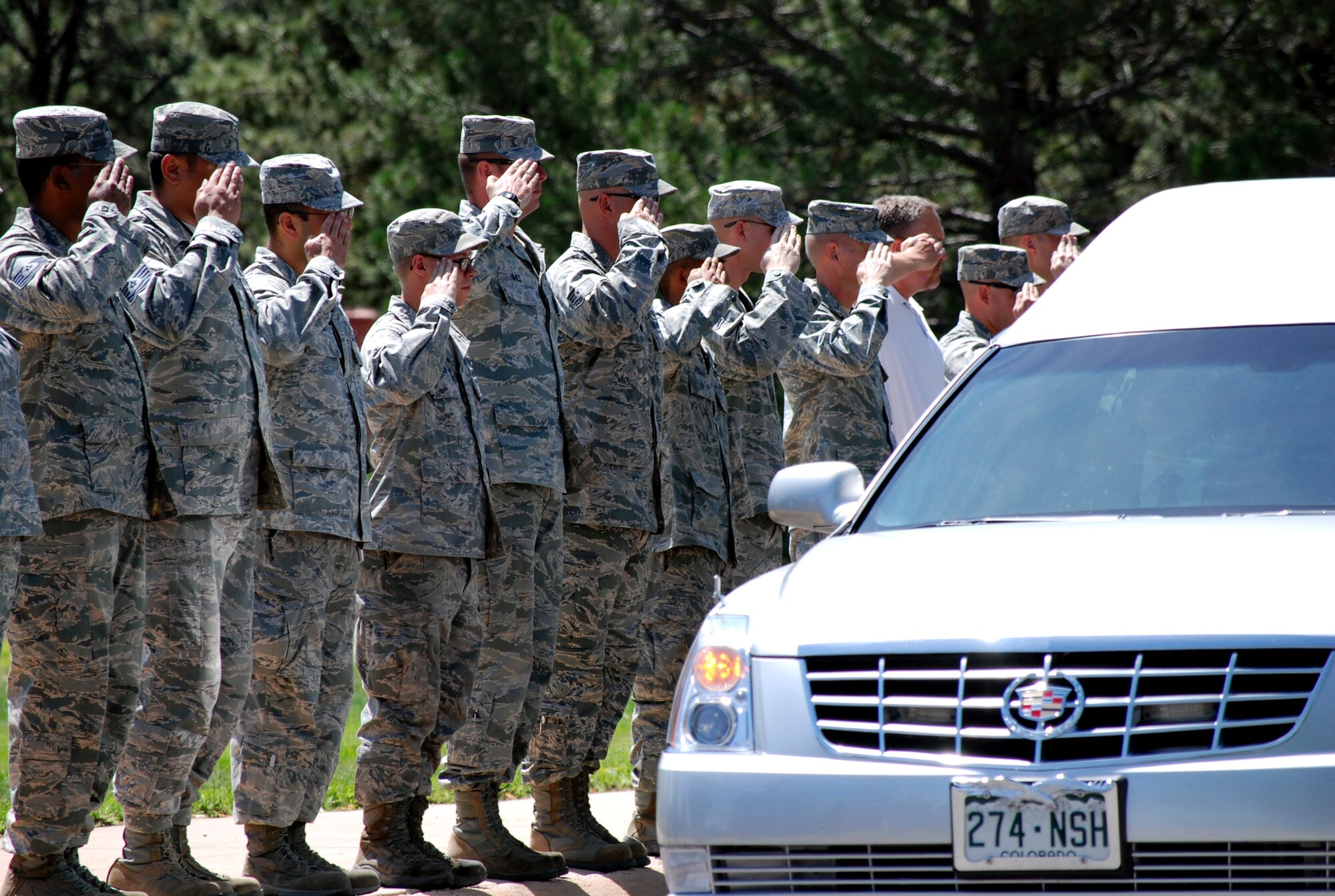 PETERSON AIR FORCE BASE, Colo. – Service members and civilians line Peterson Boulevard Aug. 2 in silent respect as the motorcade carrying the remains of Spc. Rob Lee Nichols slowly passes by. Nichols, 24, was a long-time resident of Colorado Springs, and was assigned to the 3rd Battalion, 15th Infantry Regiment at Fort Stewart, Ga. He was killed July 23 while conducting combat operations in Afghanistan. (U.S. Air Force photo/Michael Golembesky)