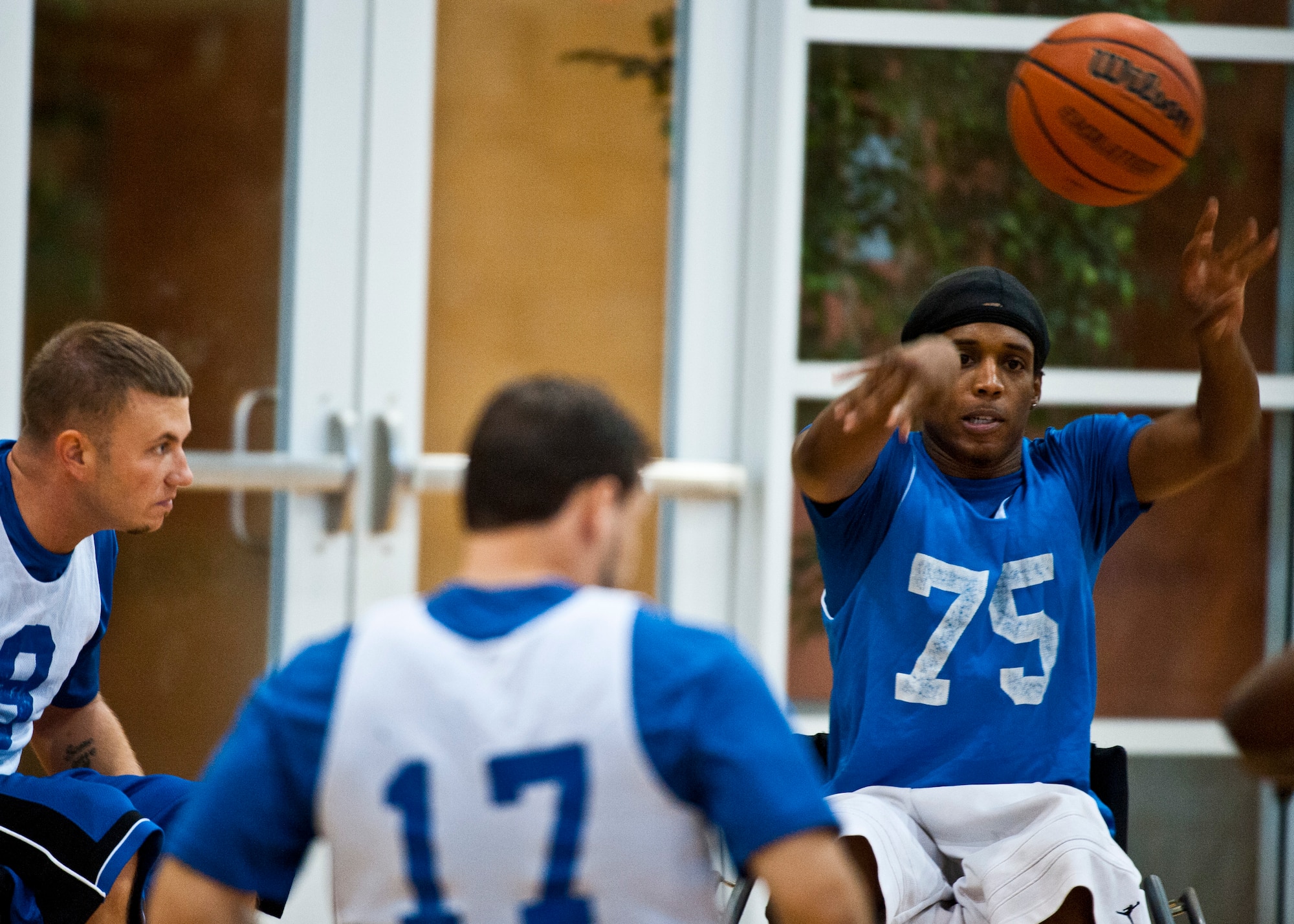 Colby Dean, an adaptive sports camp participant, passes a basketball to a teammate during a wheelchair basketball scrimmage at an Air Force Wounded Warrior Adaptive Sports Camp July 31, 2013, held at the Warrior Fitness Center at Nellis Air Force Base, Nev. The camp introduced wounded warriors to adaptive sports during their early stages of recovery. (U.S. Air Force photo/Senior Airman Brett Clashman)  