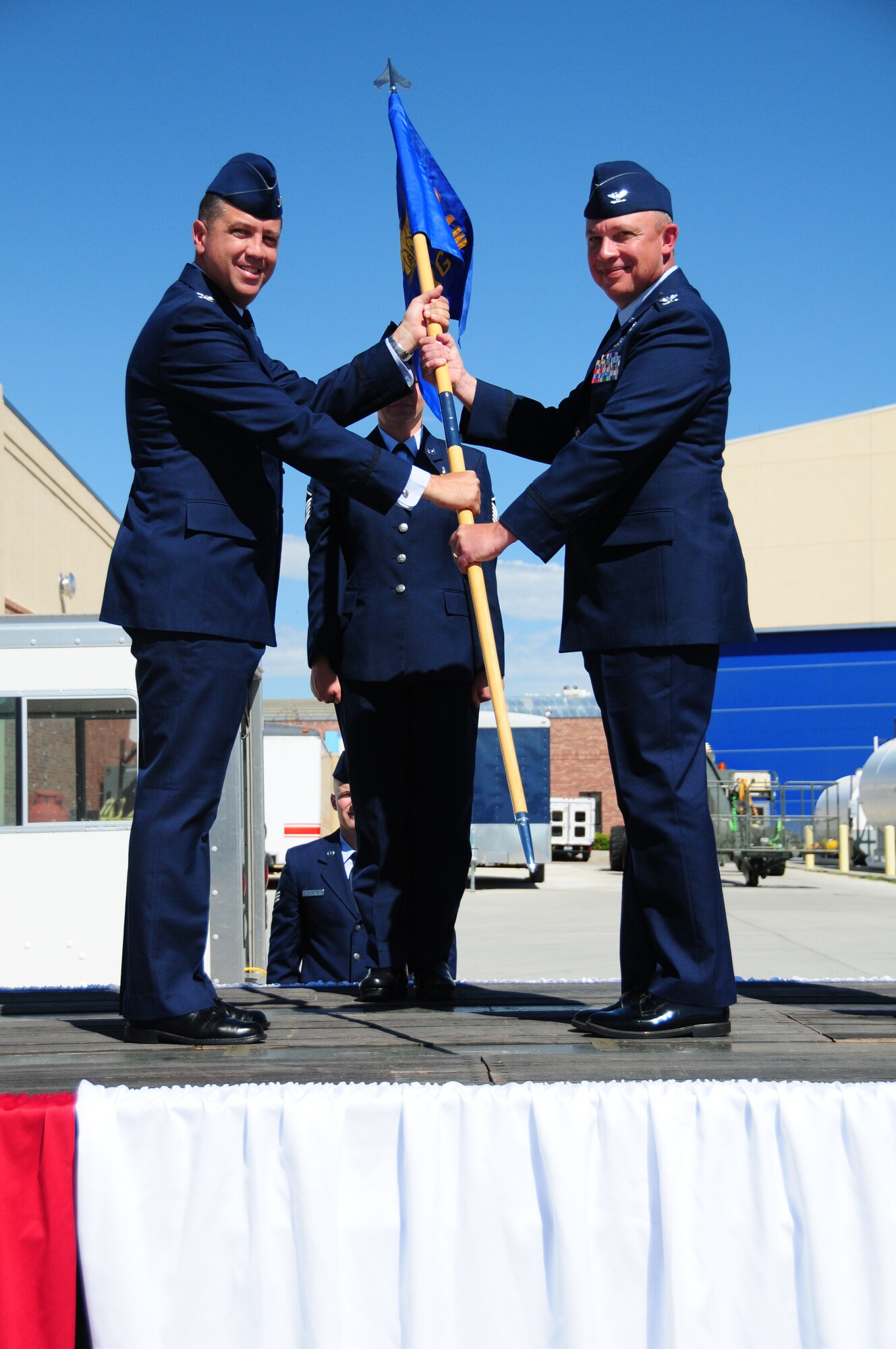Col. Peter L. "Pete" Linde, right, accepts command of the 153rd Maintenance Group from Col. Michael R. Taheri, 153rd Airlift Wing commander, during a ceremony Aug. 4, 2013 at the Wyoming Air National Guard Base, Cheyenne, Wyo. The passing of the guidon is a symbolic gesture in front of an entire unit to witness a new leader assume their dutiful position. (U.S. Air National Guard photo by Capt. Rusty Ridley)