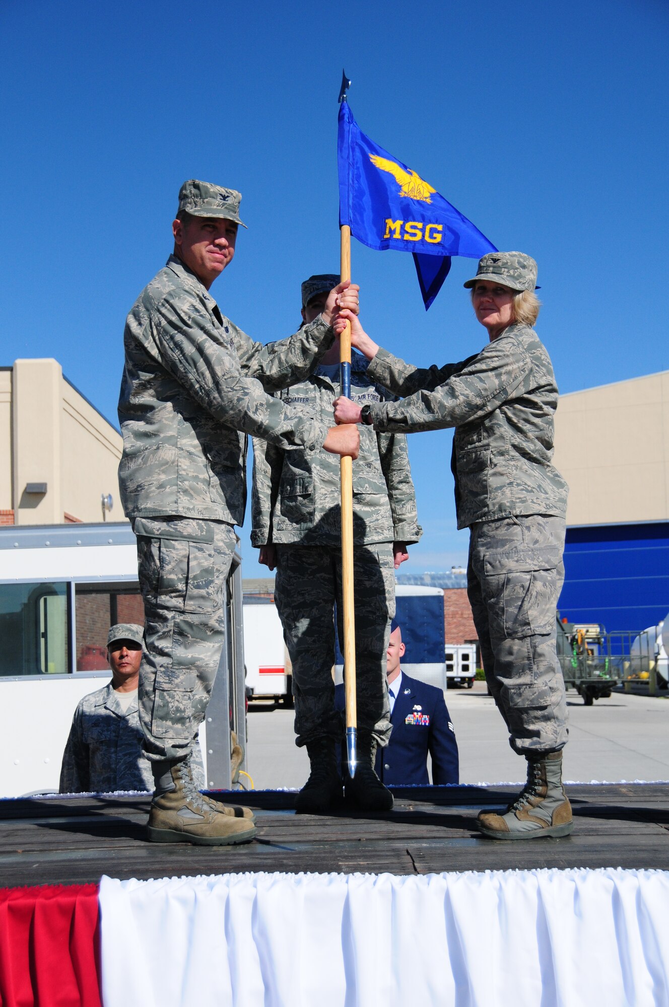 Col. Shelley R. Campbell, right, accepts command of the 153rd Mission Support Group from Col. Michael R. Taheri, 153rd Airlift Wing commander, during a ceremony Aug. 4, 2013 at the Wyoming Air National Guard Base, Cheyenne, Wyo. The passing of the guidon is a symbolic gesture in front of an entire unit to witness a new leader assume their dutiful position. (U.S. Air National Guard photo by Capt. Rusty Ridley)