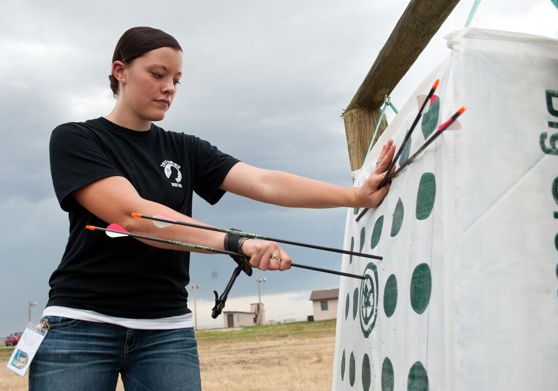 Airman 1st Class Samantha Rule, 28th Bomb Wing Staff command administrator, removes arrows from a target during the opening of the new archery range at Ellsworth Air Force Base, S.D., Aug. 1, 2013. The range has targets of various distances from 20 to 50 yards. For more information about the archery range, contact the Outdoor Recreation Center at (605) 385-2997. (U.S. Air Force photo by Airman 1st Class Alystria Maurer/Released)