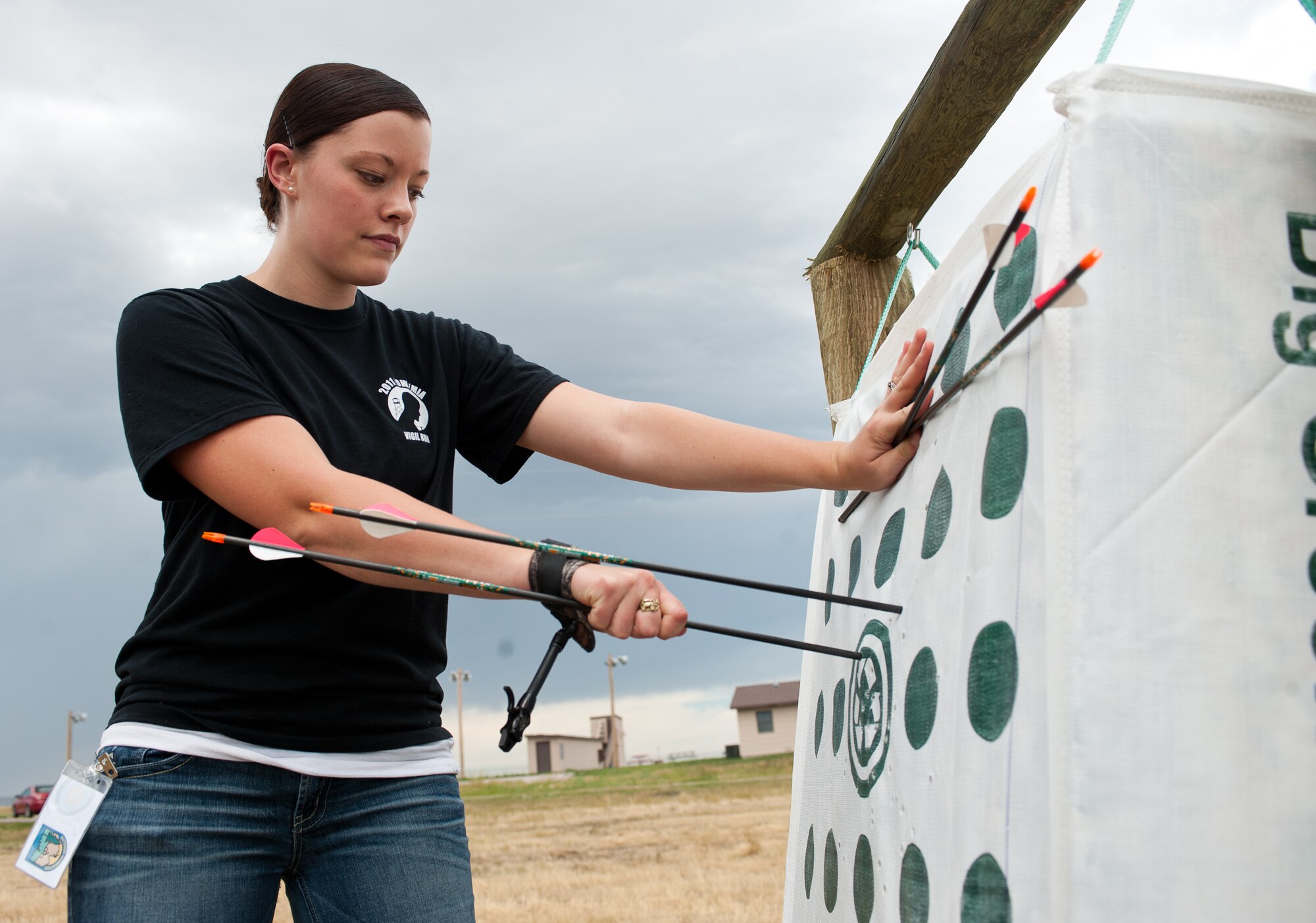 Airman 1st Class Samantha Rule, 28th Bomb Wing Staff command administrator, removes arrows from a target during the opening of the new archery range at Ellsworth Air Force Base, S.D., Aug. 1, 2013. The range has targets of various distances from 20 to 50 yards. For more information about the archery range, contact the Outdoor Recreation Center at (605) 385-2997. (U.S. Air Force photo by Airman 1st Class Alystria Maurer/Released)