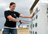 Airman 1st Class Samantha Rule, 28th Bomb Wing Staff command administrator, removes arrows from a target during the opening of the new archery range at Ellsworth Air Force Base, S.D., Aug. 1, 2013. The range has targets of various distances from 20 to 50 yards. For more information about the archery range, contact the Outdoor Recreation Center at (605) 385-2997. (U.S. Air Force photo by Airman 1st Class Alystria Maurer/Released)