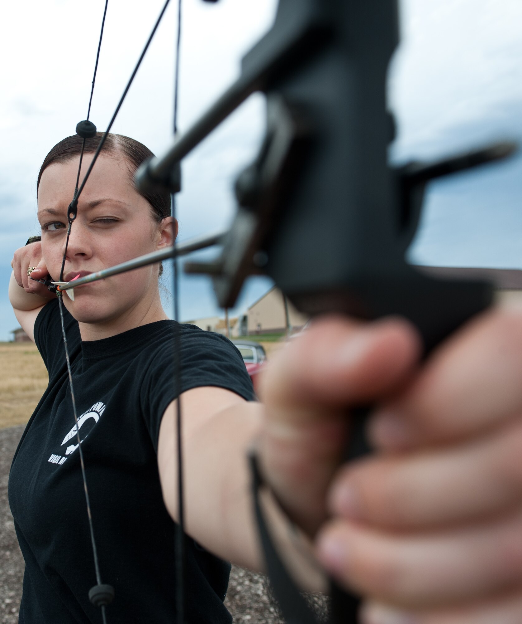 Airman 1st Class Samantha Rule, 28th Bomb Wing Staff command administrator, takes aim at a target during the opening of the new archery range at Ellsworth Air Force Base, S.D., Aug. 1, 2013. The 28th Force Support Squadron separated the archery range from the trap and skeet area to allow both facilities to be utilized simultaneously, while giving Ellsworth Airmen a bigger range and more options.  (U.S. Air Force photo by Airman 1st Class Alystria Maurer/Released)