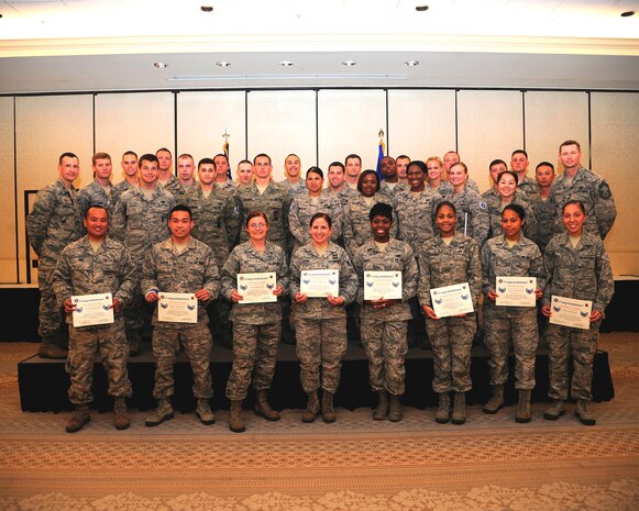 Col. Michael Mongold (left), 628th Mission Support Group commander, and Chief Master Sgt. Robert Valenca  (right), 628th MSG command chief, congratulate the 628th Air Base Wing's new staff sergeant selects at the staff sergeant promotion release cermony Aug. 1, 2013, at Joint Base Charleston - Air Base, S.C.  (U.S. Air Force photo/Tech. Sgt. Rasheen Douglas)
