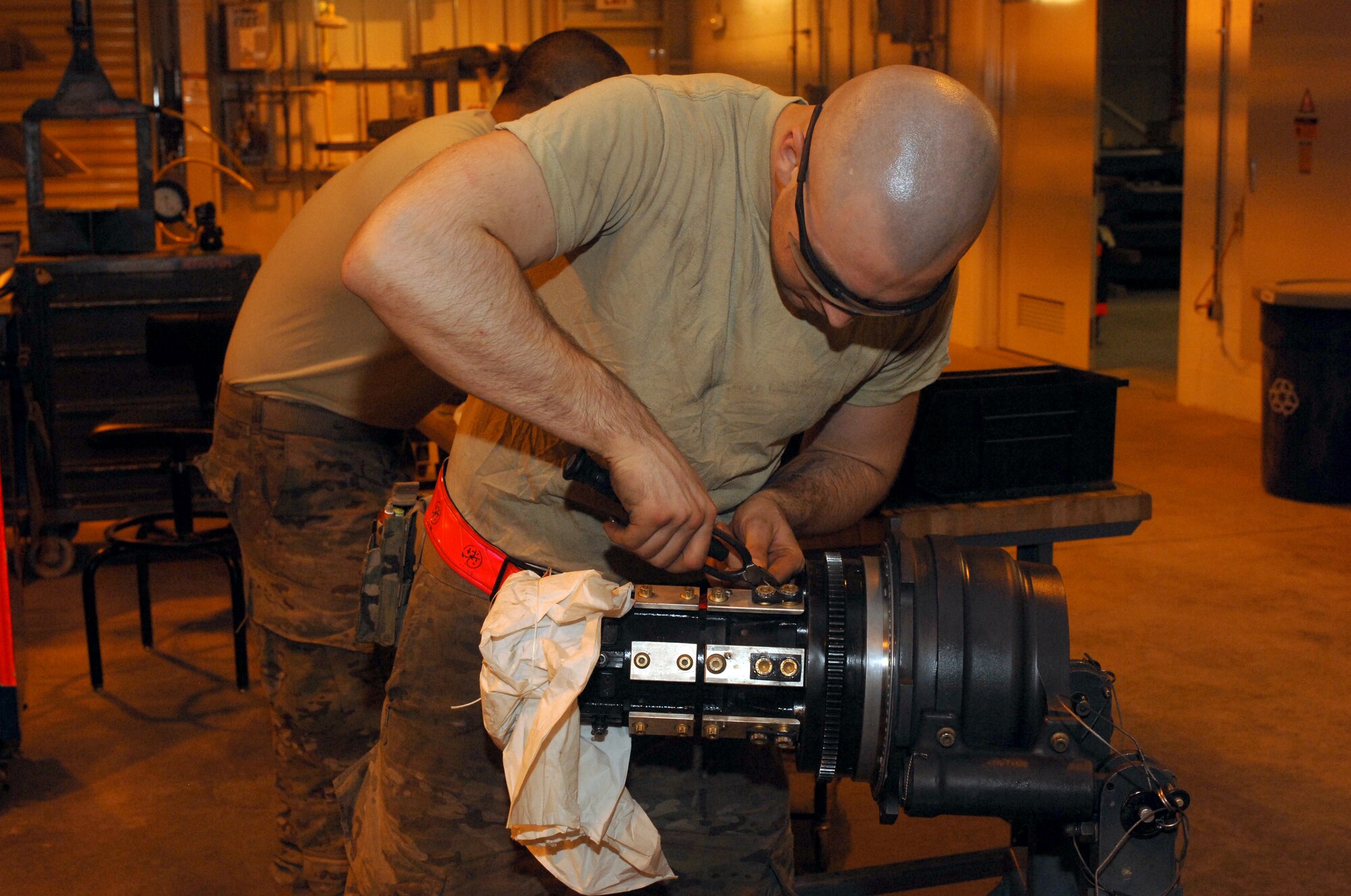 Airman 1st Class Brandon Anderson, 451st Expeditionary Maintenance Squadron armament back shop combat technician, secures safety wire to part of an F-16 Fighting Falcon weapons system during reassembly at Kandahar Airfield, Afghanistan, July 26, 2013. Airmen conduct regular maintenance to enable the wing to continue to provide close air support to NATO forces. Anderson is stationed at Spangdahlem Air Base, Germany, and is a native of Asheville, N.C. (U.S. Air Force photo by Senior Airman Jack Sanders)