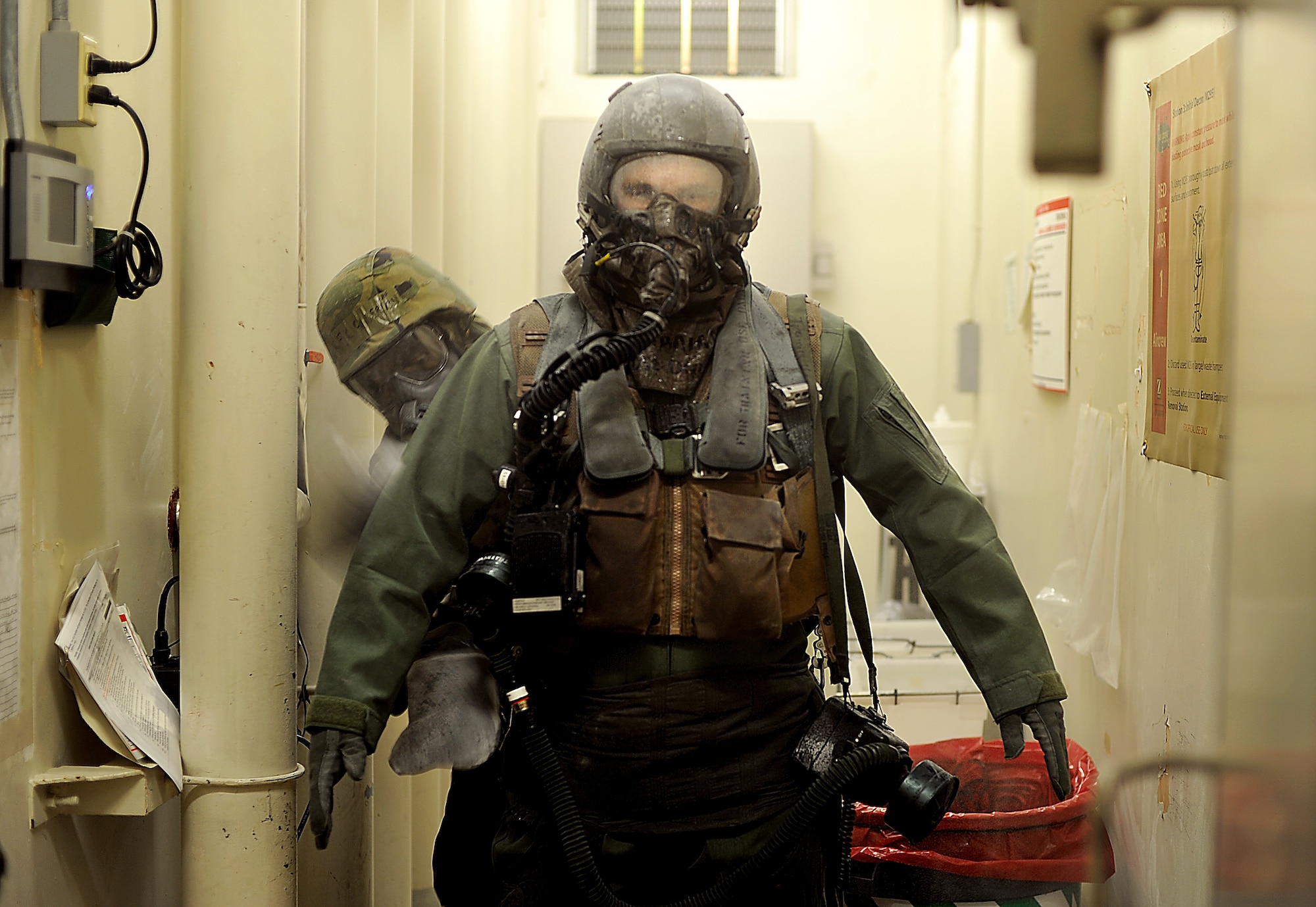 Capt. Robert Carpenter, 25th Fighter Squadron pilot, waits as he is patted down with charcoal to help decontamination after simulated exposure to a potential chemical, biological or radiological environment during Operational Readiness Exercise Beverly Midnight 13-03, Aug. 5, 2013. Throughout the week-long ORE, Airmen don Mission Oriented Protective Posture (MOPP) gear in wartime following an attack when contamination is present, suspected or when the highest level of protection is required. (U.S. Air Force photo by Staff Sgt. Sara Csurilla)