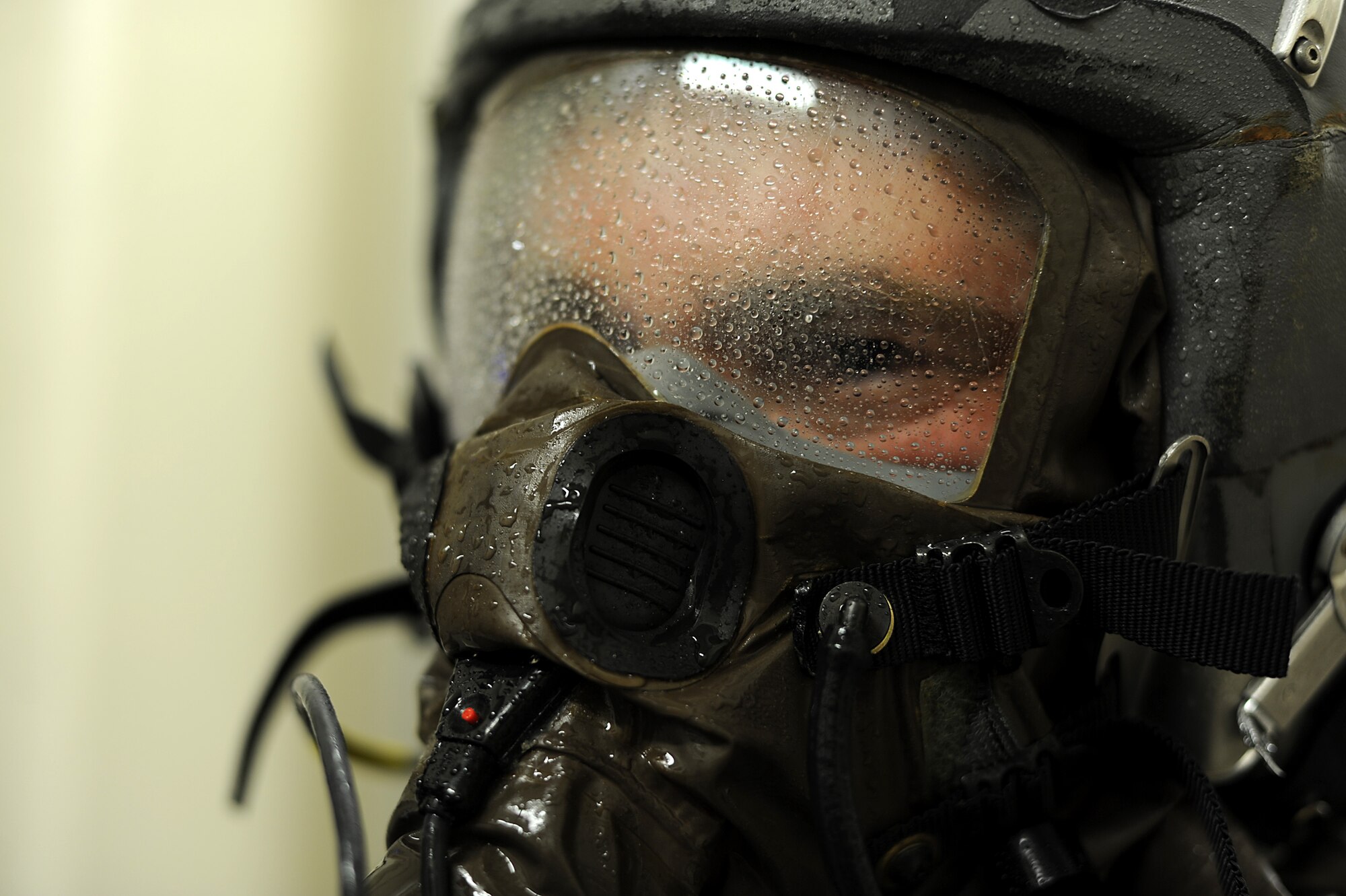 Capt. Robert Carpenter, 25th Fighter Squadron pilot, holds still while being sprayed with a solution in order to help decontaminate him after simulated exposure to a potential chemical, biological or radiological environment during Operational Readiness Exercise Beverly Midnight 13-03, Aug. 5, 2013. Osan Airmen are in the fourth simulated wartime contingency exercise executed in 2013 that will test the base's ability to defend and execute the mission in a heightened state of readiness. (U.S. Air Force photo by Staff Sgt. Sara Csurilla)