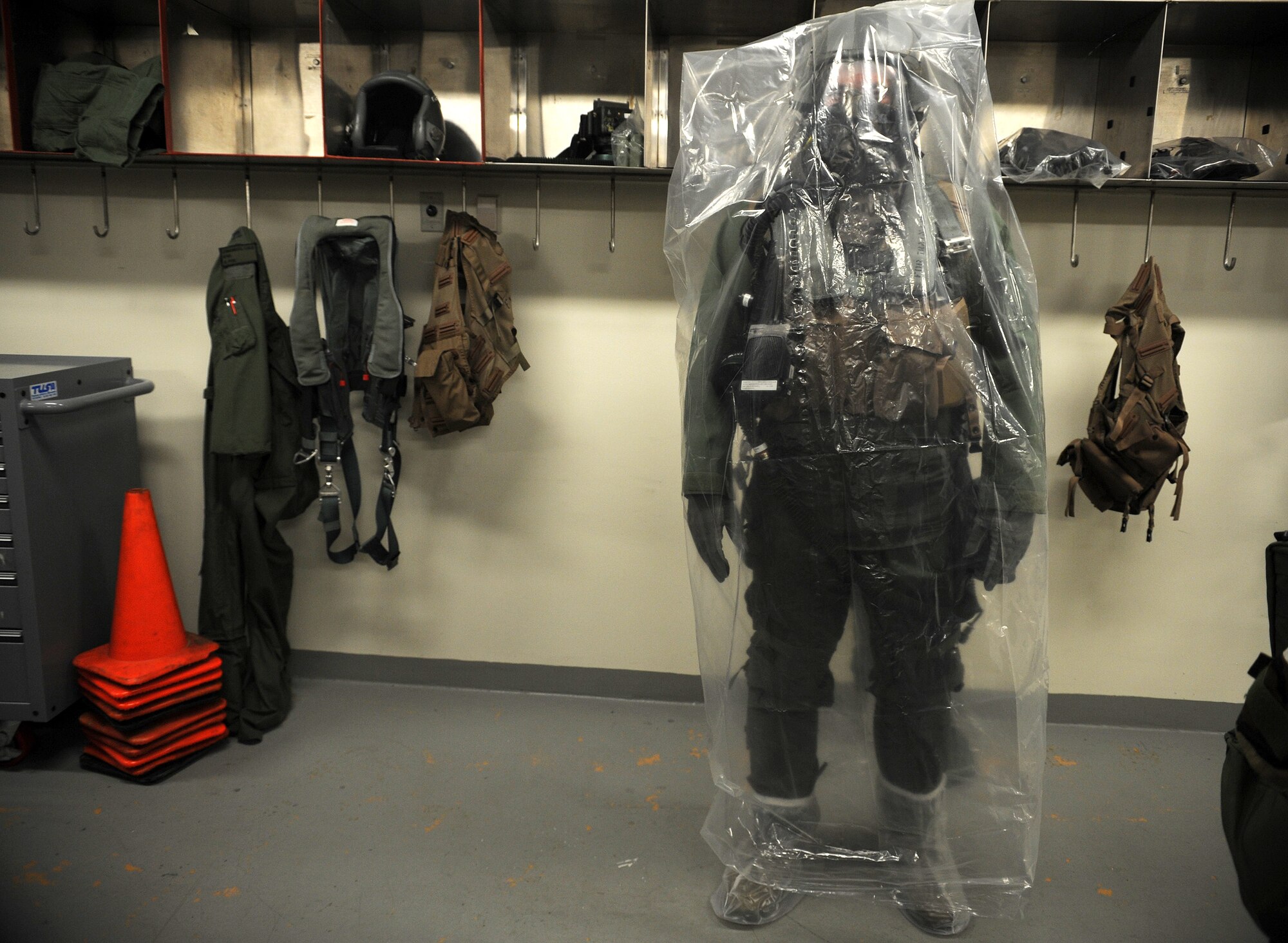 Capt. Robert Carpenter, 25th Fighter Squadron pilot, stands by before going through a decontamination process during Operational Readiness Exercise Beverly Midnight 13-03, at Osan Air Base, Republic of Korea, Aug. 5, 2013. Pilots from the 25th and 36th Fighter Squadrons practice wearing Aircrew Eye and Respiratory Protection equipment during OREs to prepare themselves for a potential chemical, biological or radiological environment. Throughout the week, Airmen at Osan will undergo several different scenarios that will test their ability to defend the base and conduct daily operations during a heightened state of readiness. (U.S. Air Force photo by Staff Sgt. Sara Csurilla)