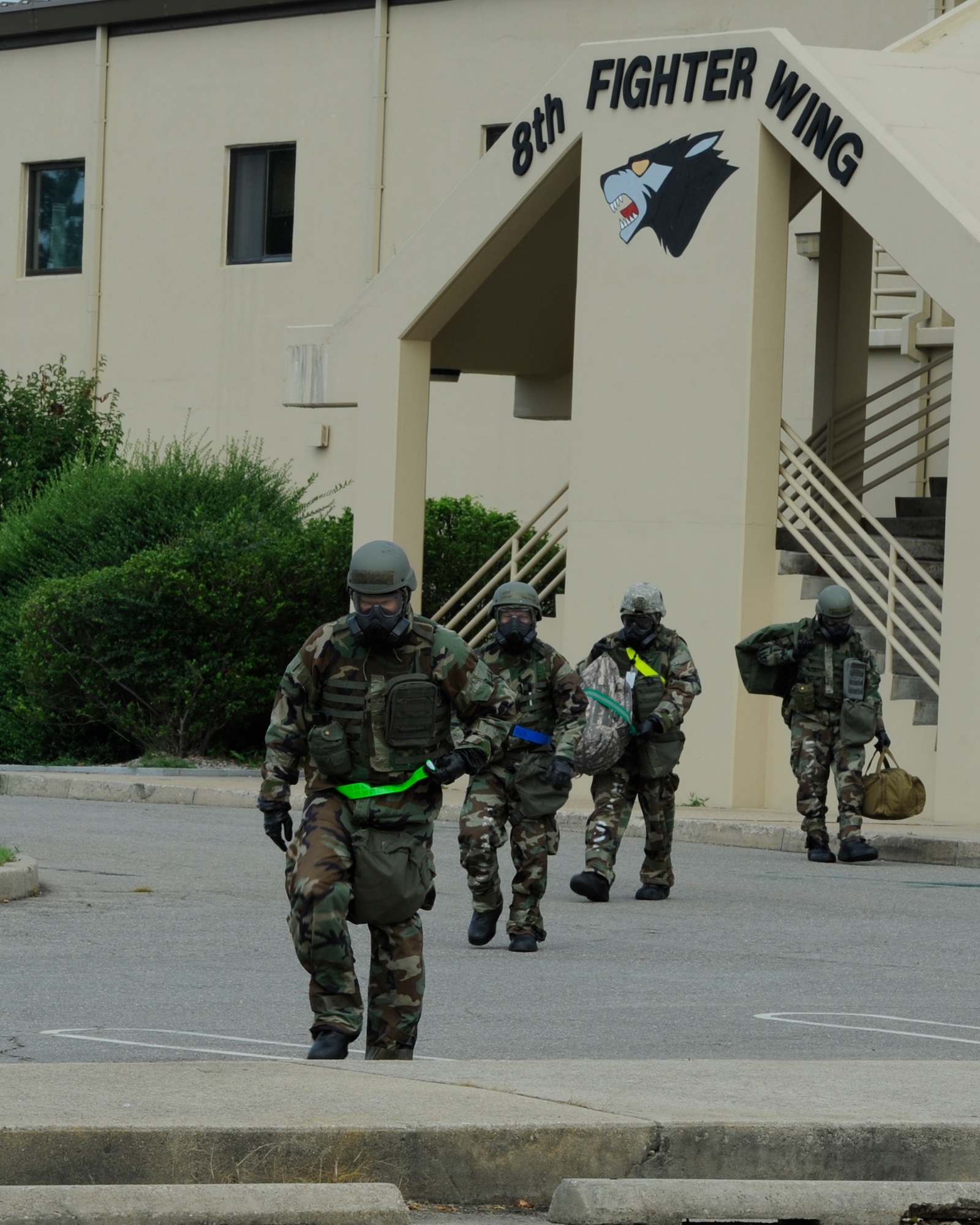 KUNSAN AIR BASE, Republic of Korea -- Members of the 8th Fighter Wing staff relocate after a simulated fire in their building during exercise Beverly Midnight 13-3, Aug. 6, 2013. In addition to the Mission Oriented Protective Posture gear, the scenario was designed to add a level of stress to test their ability to operate from an alternate site. (U.S. Air Force photo by Staff Sgt. Tong Duong/Released)