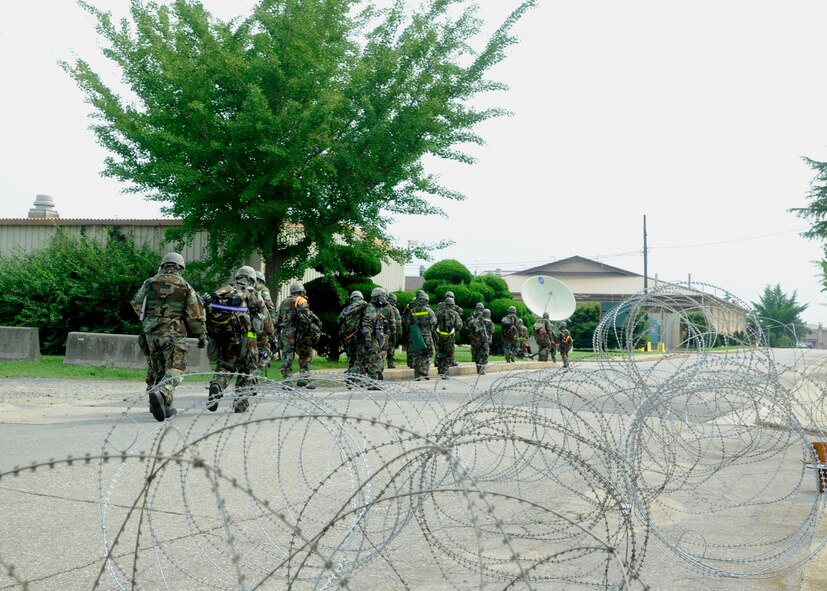 KUNSAN AIR BASE, Republic of Korea – Wolf Pack leadership evacuates their facility during a Beverly Midnight 13-3 simulated missile attack, Aug. 6, 2013. Exercise Evaluation Teams tested the evacuation and how efficiently service members responded to enemy forces. (U.S. Air Force photo by Staff Sgt. Jessica Haas/Released) 

