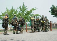 KUNSAN AIR BASE, Republic of Korea -- Base leadership evacuates their building during a Beverly Midnight 13-3 simulated missile attack, Aug. 6, 2013. This particular scenario tested the Wolf Pack leadership’s ability to function in an alternate location. (U.S. Air Force photo by Staff Sgt. Jessica Haas/Released) 