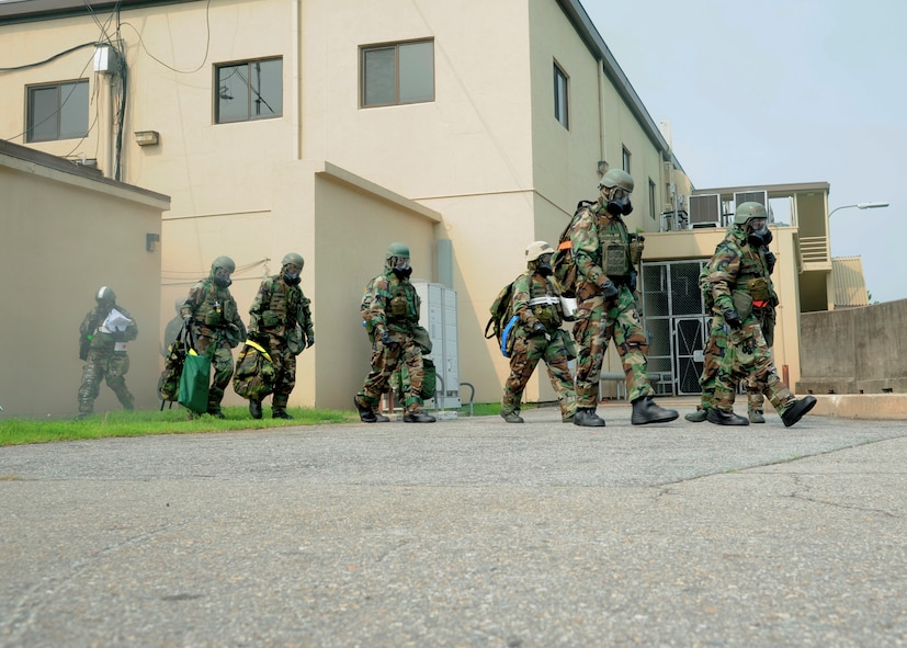 KUNSAN AIR BASE, Republic of Korea -- Base leadership evacuates their building during a simulated missile attack, Aug. 6, 2013. The simulated attack was one of many different incidents to occur during Beverly Midnight 13-3, an exercise held to test the Wolf Pack’s ability to respond during wartime scenarios. (U.S. Air Force photo by Staff Sgt. Jessica Haas/Released) 