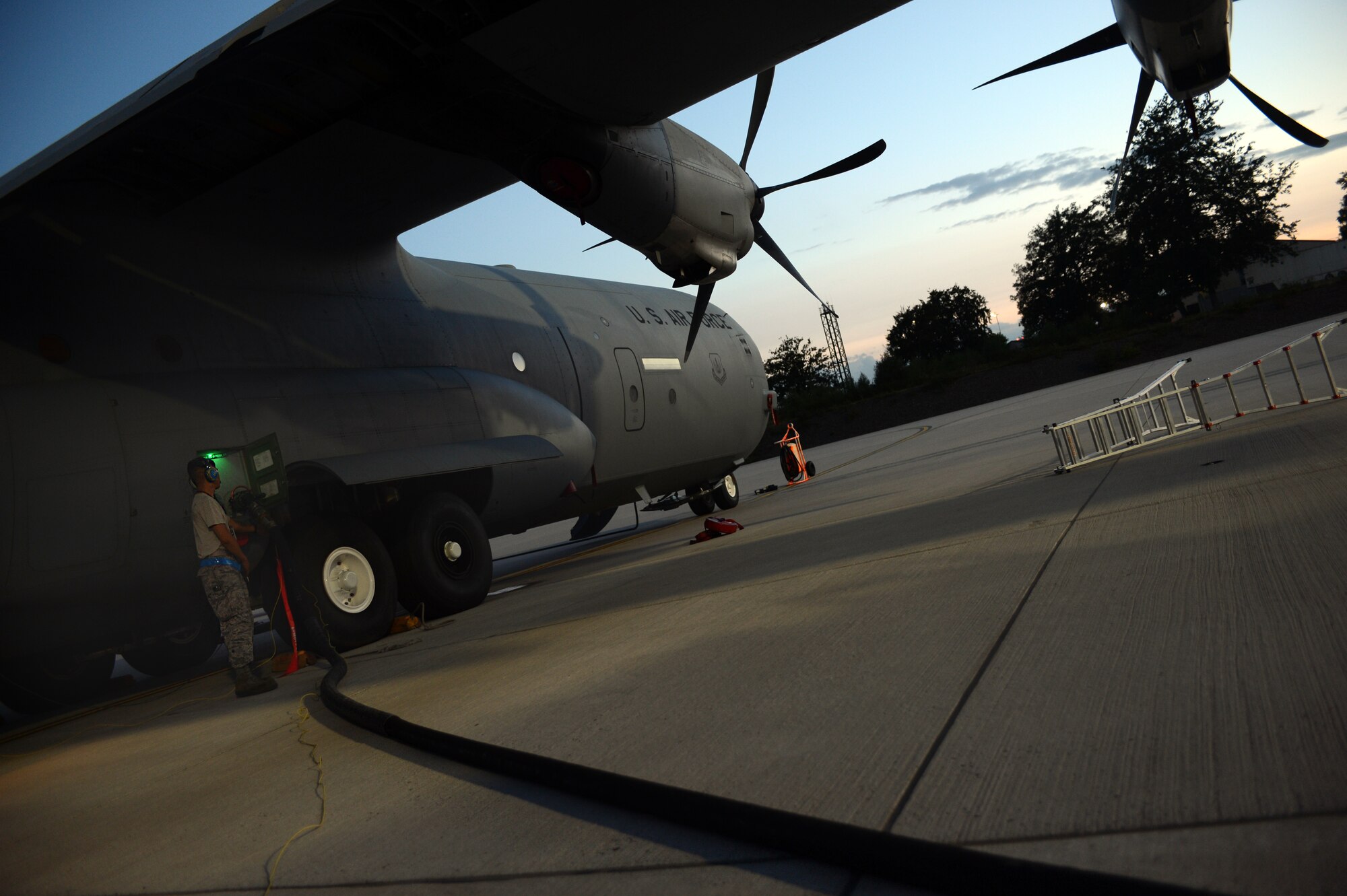 Staff Sgt. Roscoe Tamondong, 86th Aircraft Maintenance Squadron flight crew chief, refuels a C-130J Super Hercules, July 29, 2013, Ramstein Air Base, Germany. 86th AMXS Airmen ensure all assigned aircraft are 100 percent combat ready prior to take off. (U.S. Air Force photo/Senior Airman Caitlin Guinazu)