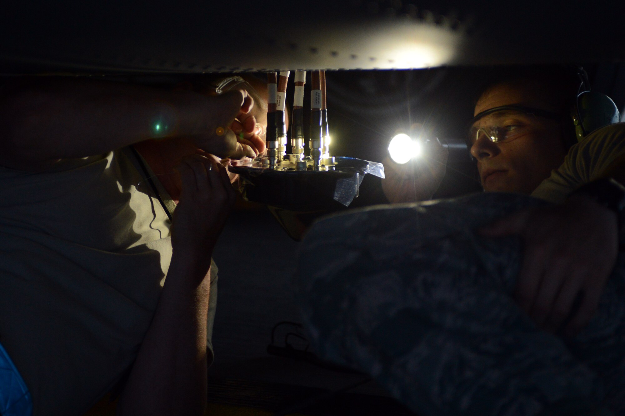 Airmen 1st Class Alan Pardon (right) and Levi Paradee (left), 86th Aircraft Maintenance Squadron electronic warfare apprentices, replace an antenna underneath a C-130J Super Hercules, July 29, 2013, Ramstein Air Base, Germany. 86th AMXS Airmen ensure all assigned aircraft are 100 percent combat ready prior to take off. (U.S. Air Force photo/Senior Airman Caitlin Guinazu)