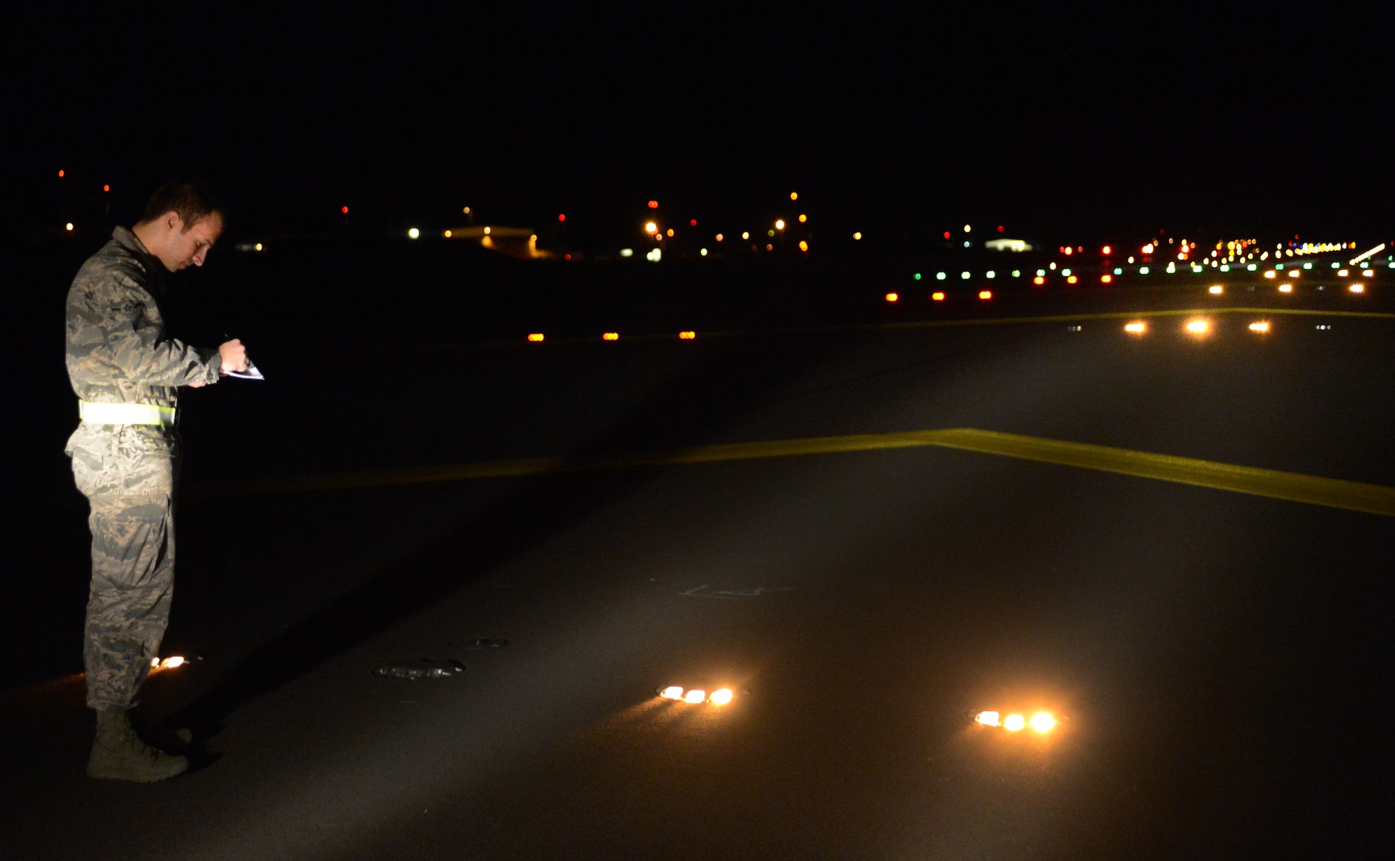 Airman Brandon Horning, 86th Operational Support Squadron airfield management operations coordinator, inspects and records the location of malfunctioning lights on the airfield, July 31, 2013, Ramstein Air Base, Germany. The 86th OSS airfield management flight works around-the-clock to ensure the airfield is a safe and operational environment. (U.S Air Force photo/Senior Airman Caitlin Guinazu)