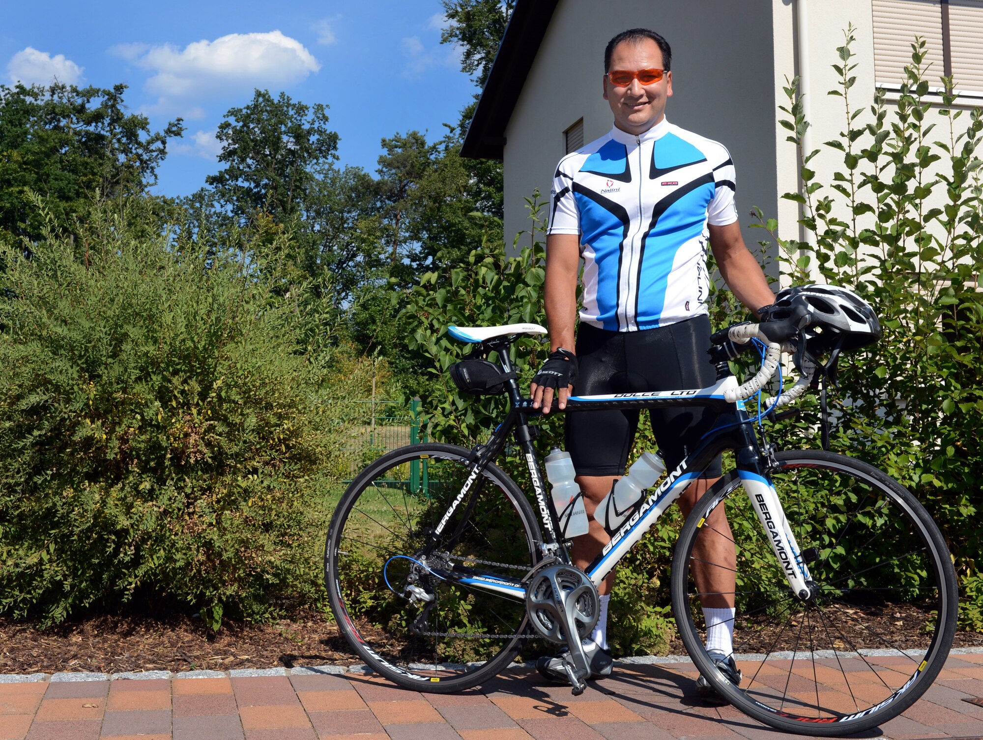 Lt. Col. Jason Dudjak, U.S. Air Forces in Europe and Air Forces Africa Expeditionary Operations Branch chief, poses next to his bike July 23. Dudjak will make a 425-mile trip, biking from Ramstein to the Brandenburg Gate in Berlin. Dudjak has trained four months for this five-day trip. He will bike 60 to 100 miles each day and will be hosted in guest houses along the way for rest and recuperation. Although Dudjak has traveled through Germany over the course of his tour, his hope is to experience the country at a slower pace and get the chance to interact with the locals. The road trip begins Aug. 4. Visit the Ramstein Air Base Web page to view photos and track his progression throughout his journey. (U.S. Air Force photo/Senior Airman Caitlin Guinazu)