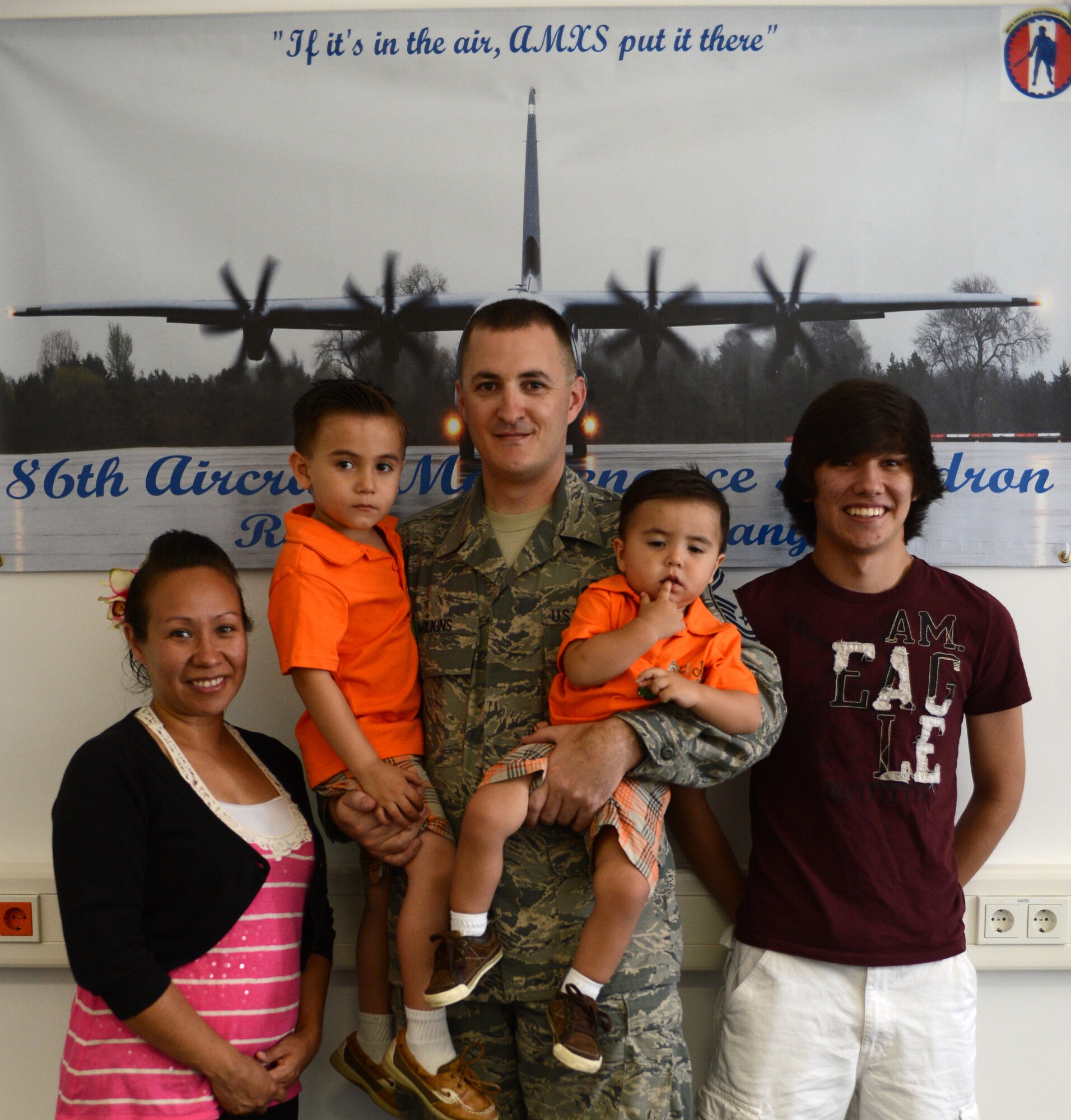 Senior Master Sgt. Jonathan Wilkins and wife Gina, pose with sons, July 27, 2013, Ramstein Air Base, Germany. Wilkins is scheduled to deploy in Aug for a 365 day TDY, making this his third deployment and second short tour. His wife Gina is pregnant with a girl and will be giving birth in November. (U.S. Air Force photo/Senior Airman Caitlin Guinazu)

