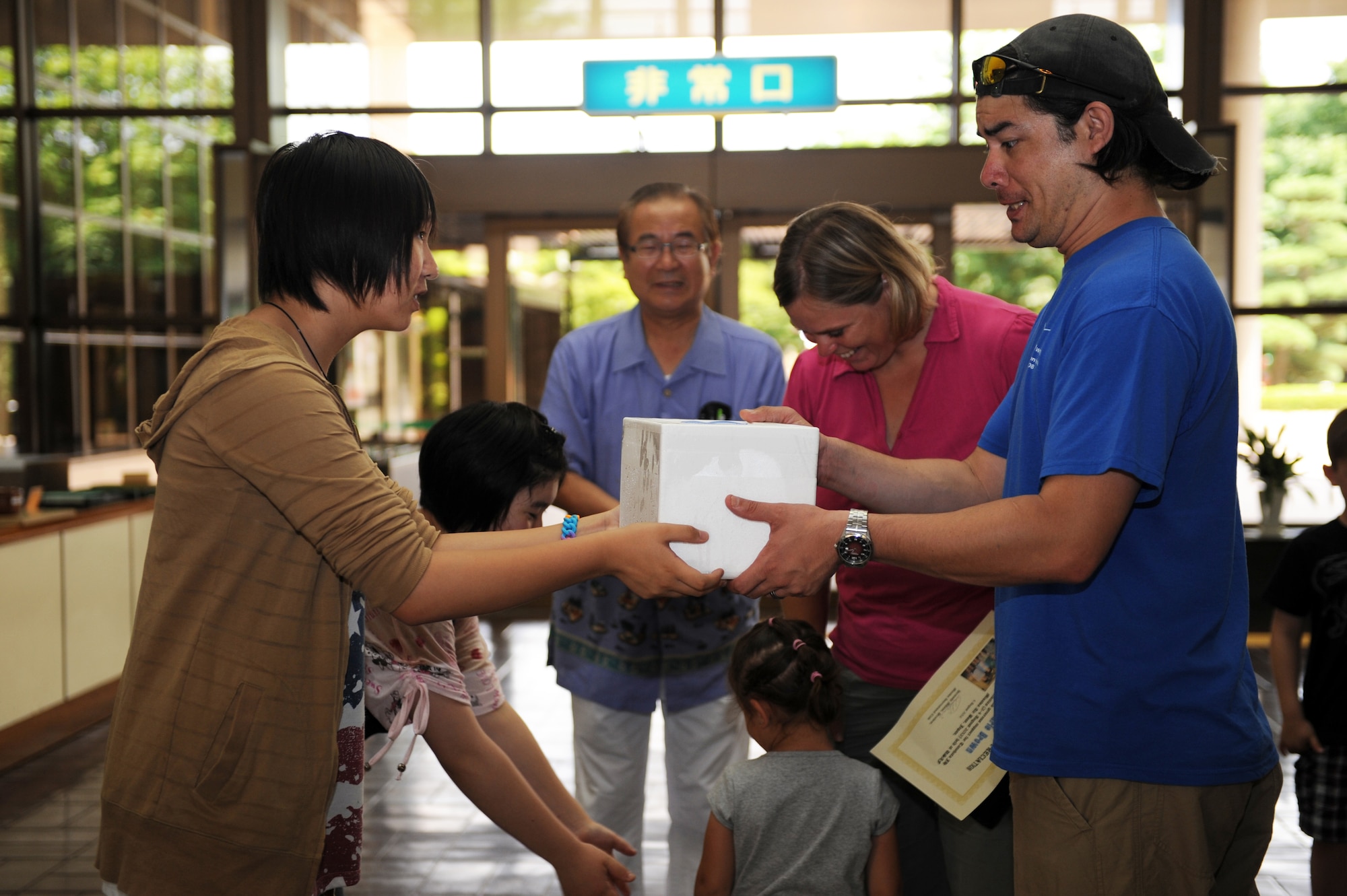 Nanase Abe and Amane Nakamura, students from Tanohata Junior High School, give thanks and say goodbye to U.S. Air Force Tech. Sgt. Marie Brown, 35th Fighter Wing Public Affairs NCO in charge of U.S. media relations, her daughter and her husband, Dave Brown, during the closing ceremony of the weekend Homestay event at the Civic Center in Misawa City, Japan, Aug. 4, 2013. Military families at Misawa Air Base welcomed students into their homes to experience American culture. (U.S. Air Force photo by Senior Airman Kia Atkins)