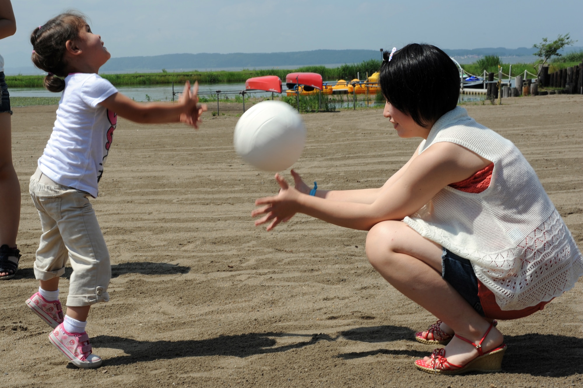 Daughter of U.S. Air Force Tech. Sgt. Marie Brown, 35th Fighter Wing Public Affairs NCO in charge of U.S. media relations, throws a ball to Amane Nakamura, a student from Tanohata Junior High School, during a weekend Homestay event at Misawa Air Base, Japan, Aug. 3, 2013. This is the second Homestay this year that the base has hosted for students from areas that were highly affected by the March 2011 earthquake and tsunami. The base also hosts homestays for local students from Misawa. (U.S. Air Force photo by Senior Airman Kia Atkins)
