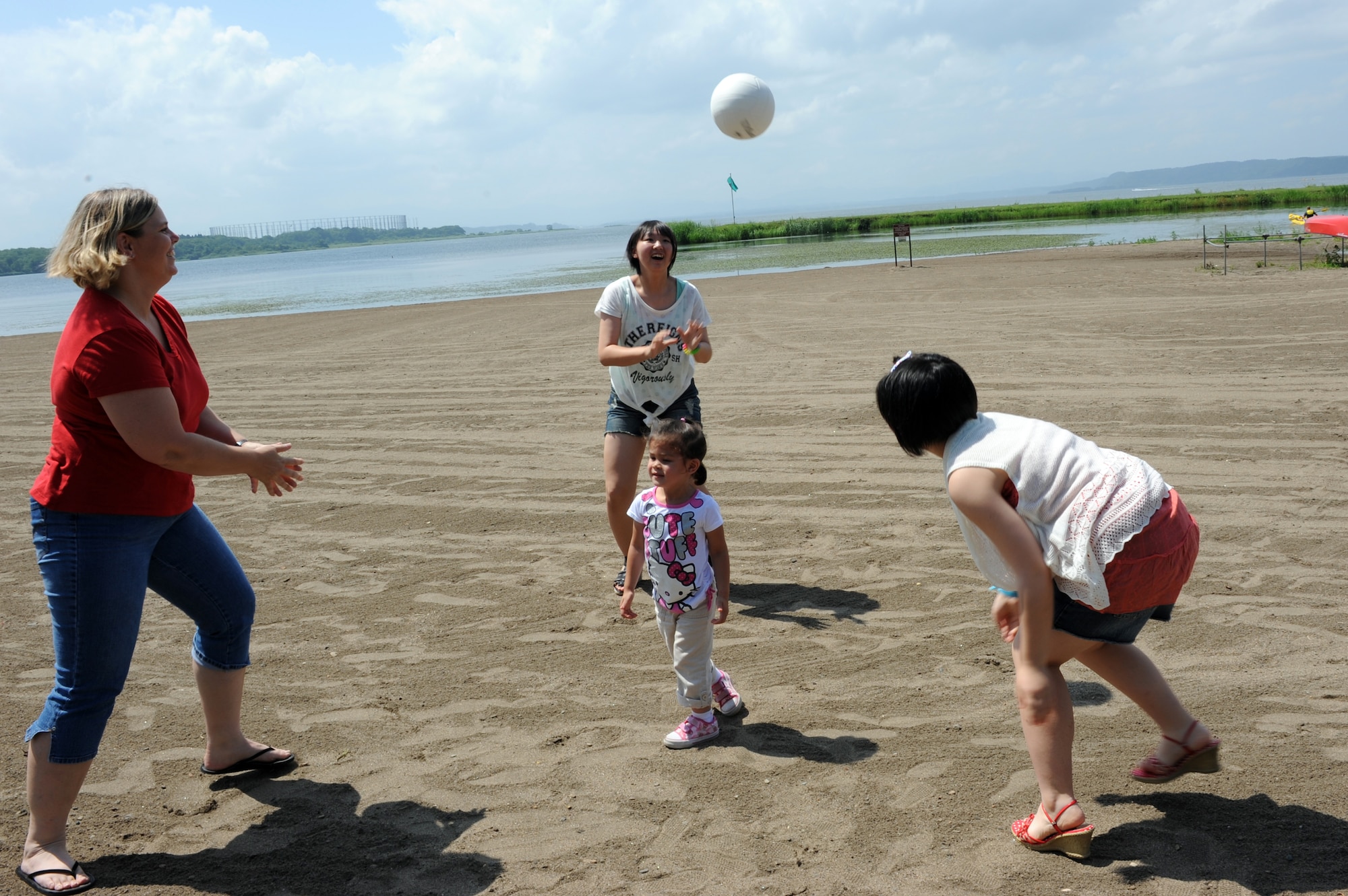 U.S. Air Force Tech. Sgt. Marie Brown, left, 35th Fighter Wing Public Affairs NCO in charge of U.S. media relations, her daughter, center, Amane Nakamura, right, and Nanase Abe play a game of volleyball during a weekend Homestay event at Misawa Air Base, Japan, Aug. 3, 2013. The students that were a part of this Homestay are from Iwate prefecture, which was highly affected by the tsunami and earthquake more than two years ago. (U.S. Air Force photo by Senior Airman Kia Atkins)