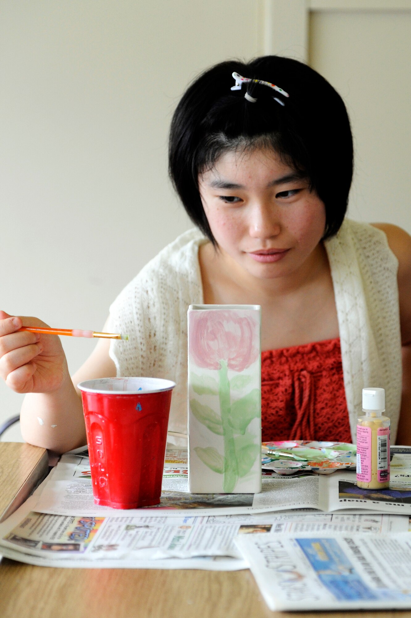 Amane Nakamura, a student from Tanohata Junior High School, paints a ceramic vase during a weekend Homestay event at Misawa Air Base, Japan, Aug. 3, 2013. Nakamura was one of eight students from a recovering area where the March 2011 earthquake and tsunami hit, and stayed with U.S. Air Force Tech. Sgt. Marie Brown, 35th Fighter Wing Public Affairs NCO in charge of U.S. media relations, and her family for the weekend where they shared cultures and learned about each other. (U.S. Air Force photo by Tech. Sgt. Marie Brown)